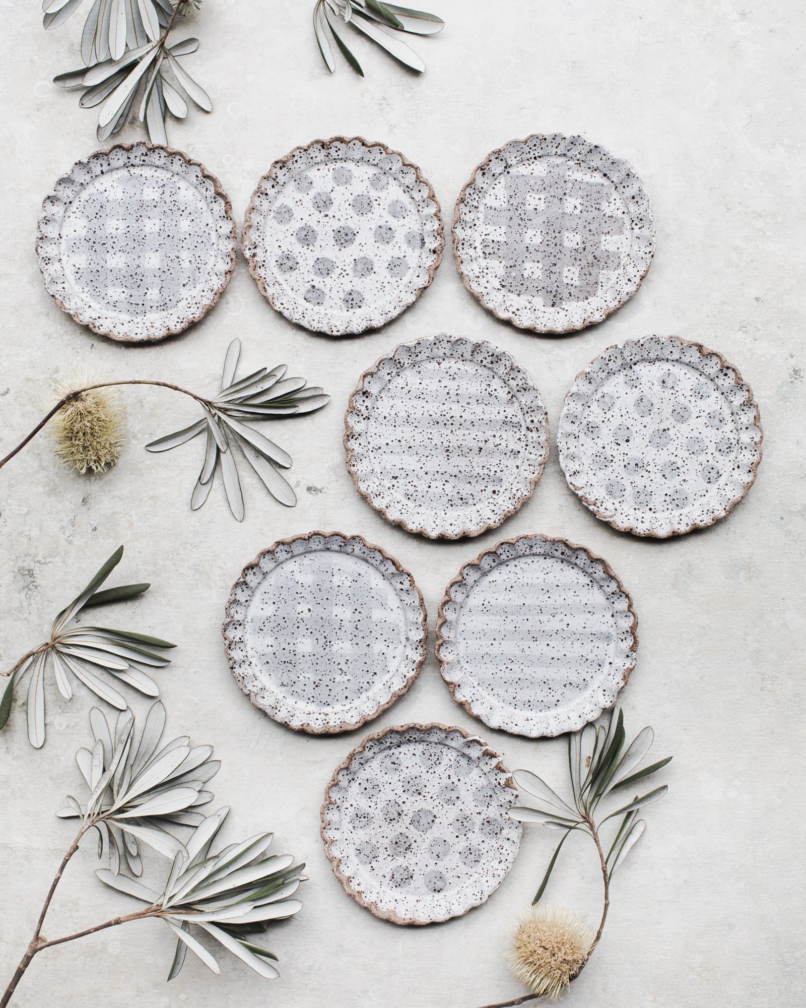 Speckled cake plates with scalloped rims handmade by clay beehive ceramics