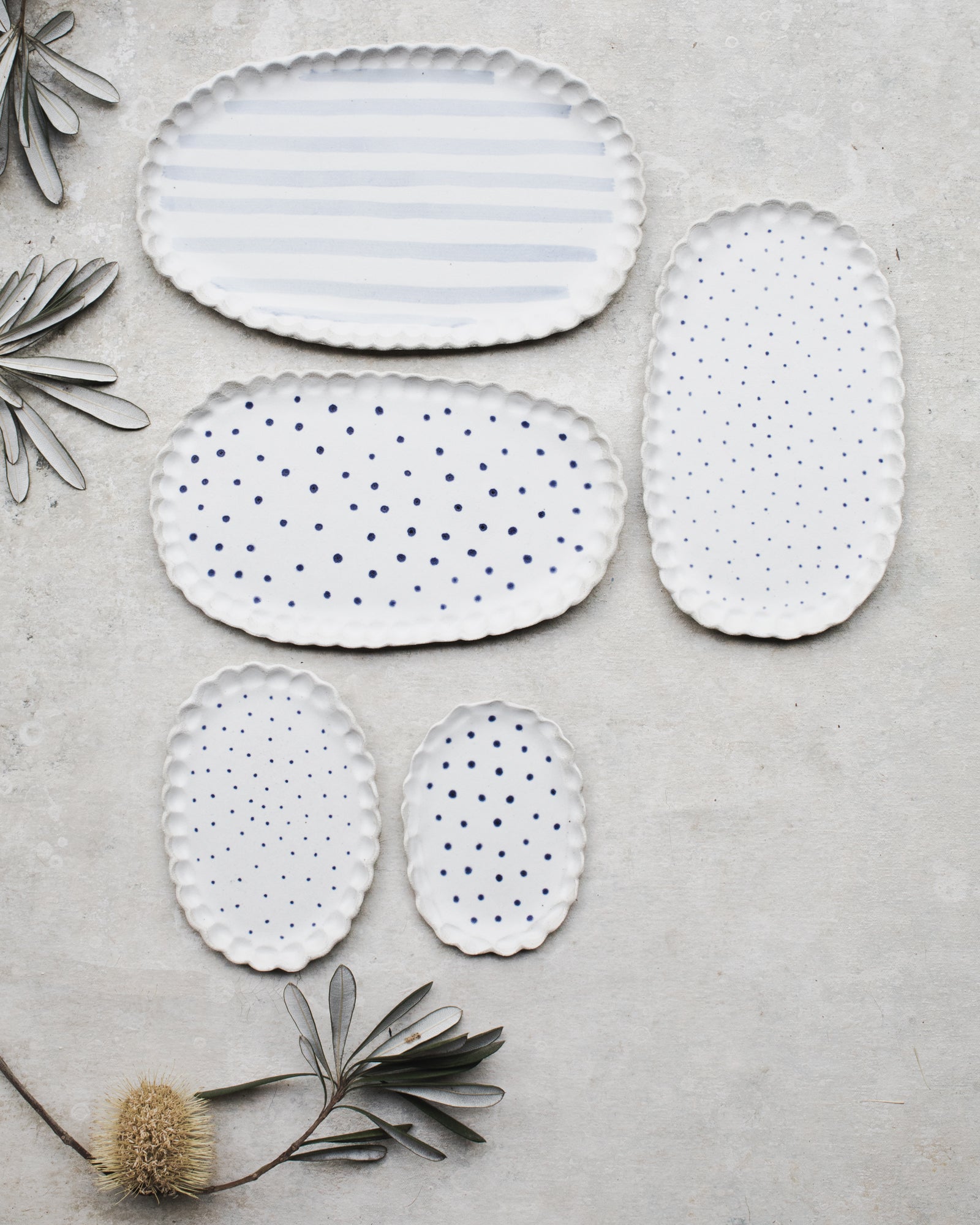 Scalloped rim blue and white spot and lines oval shaped plates by clay beehive ceramics