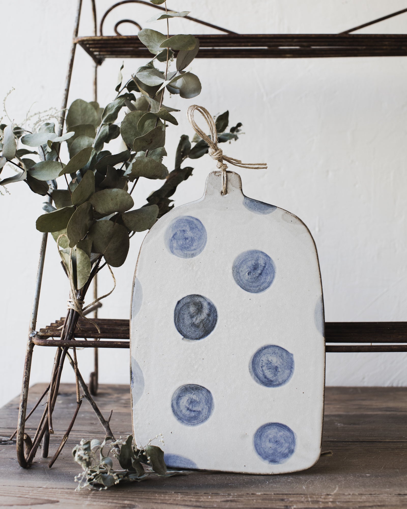 Dark Stoneware cheeseboard with large polka dots in navy and satin white finish by clay beehive ceramics