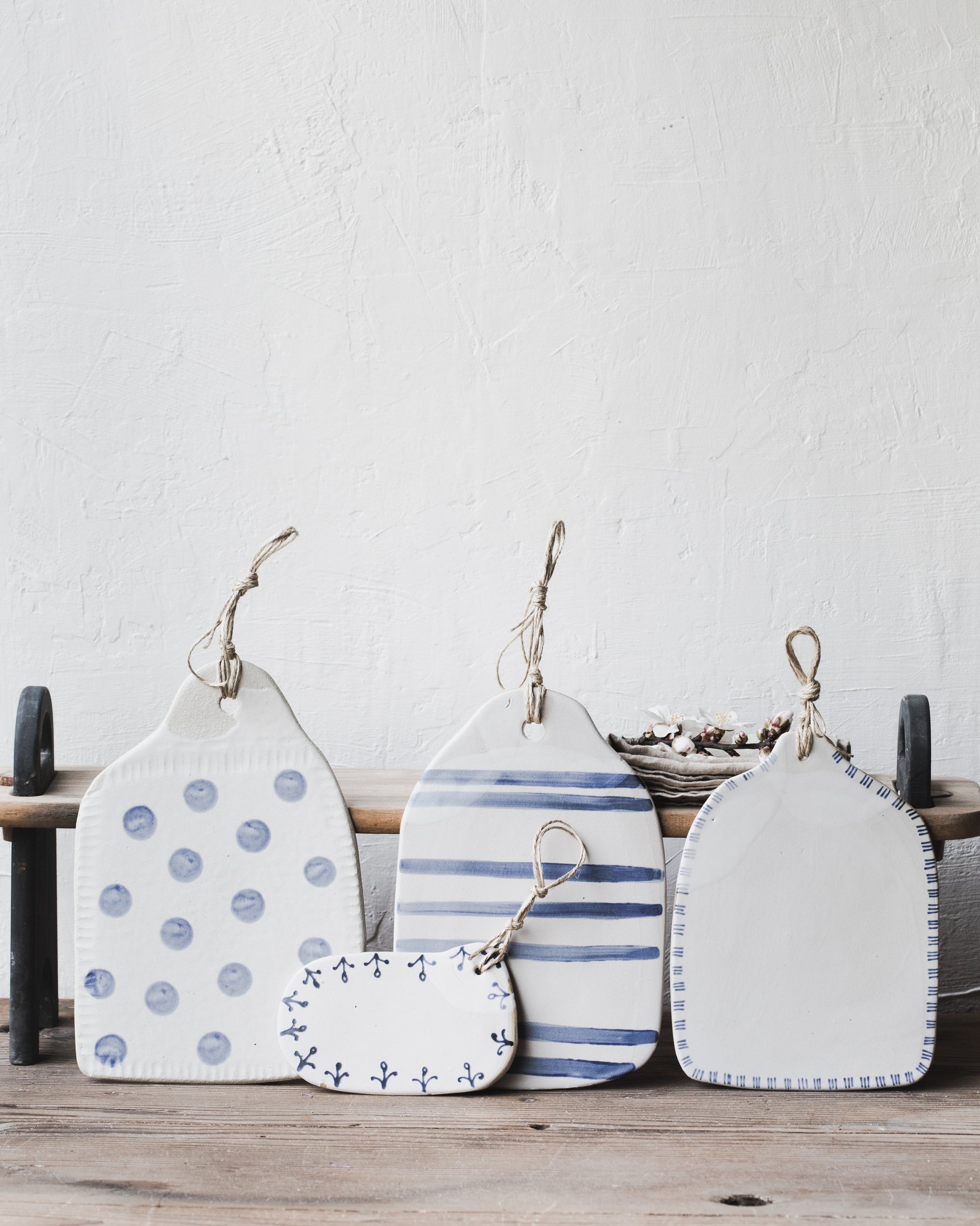 Blue and white rustic cheeseboards with hemp handle handmade by clay beehive ceramics
