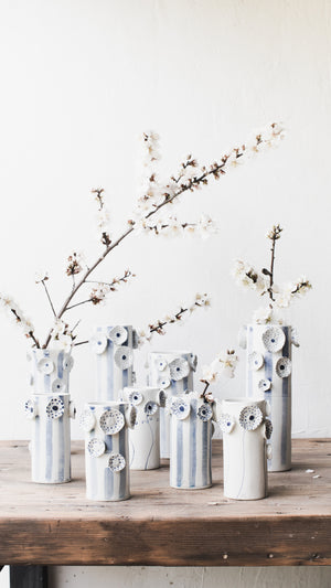 Blue and white flowers and lines tall vases with spring alomond blossoms handmade by clay beehive ceramics