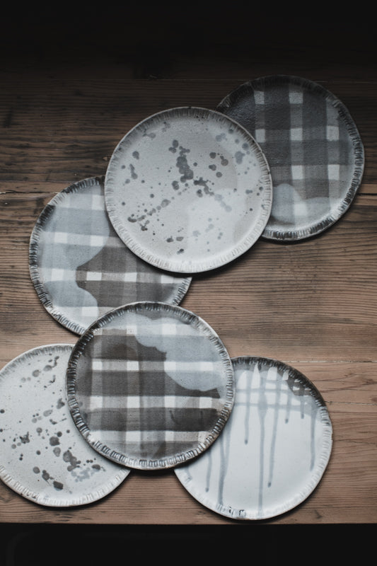 Patterned plates with carved rim by clay beehive
