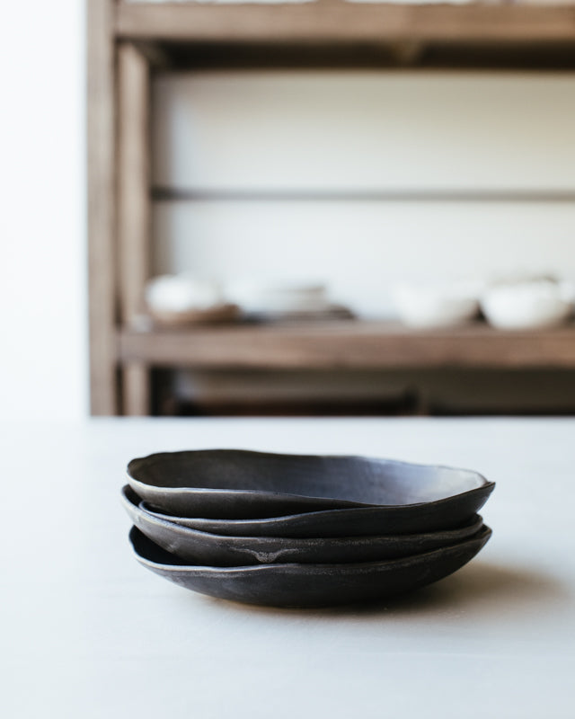 Organic shaped bowls finished in a soft satin matte black glaze