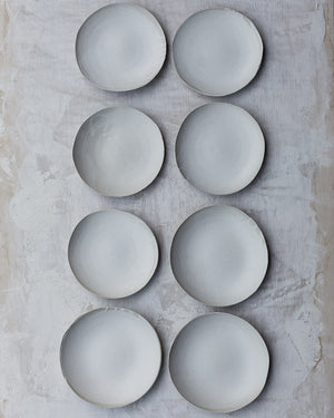 flatlay of white organic shallow bowls with satin white glaze by clay beehive ceramics
