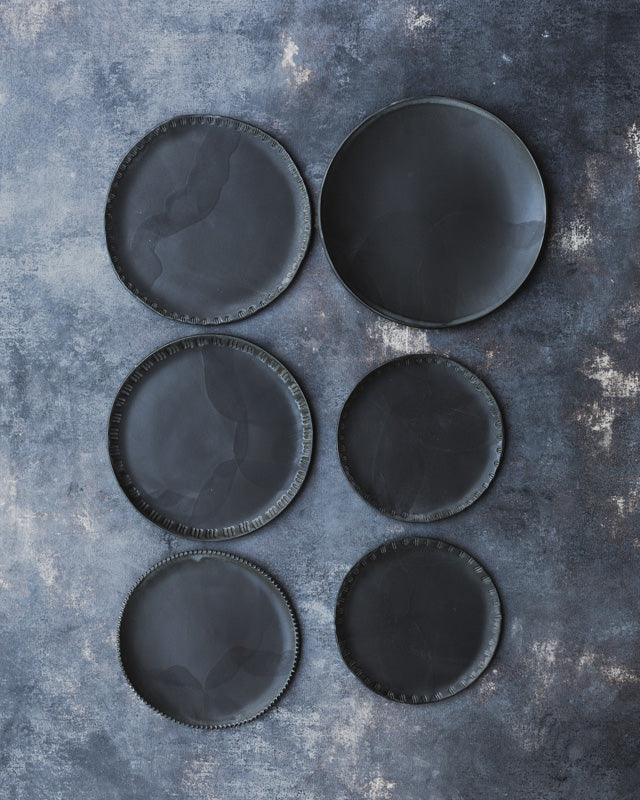 satin black hand made ceramic plates with textured rims by clay beehive