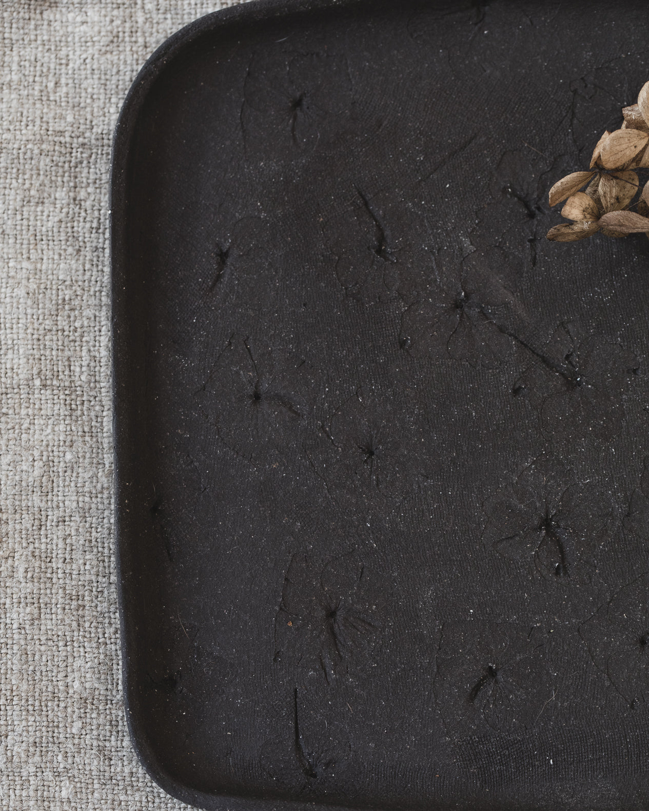 Handmade matte black rectangular plates/tray with hydrangea flower imprints, handmade by clay beehive ceramics.