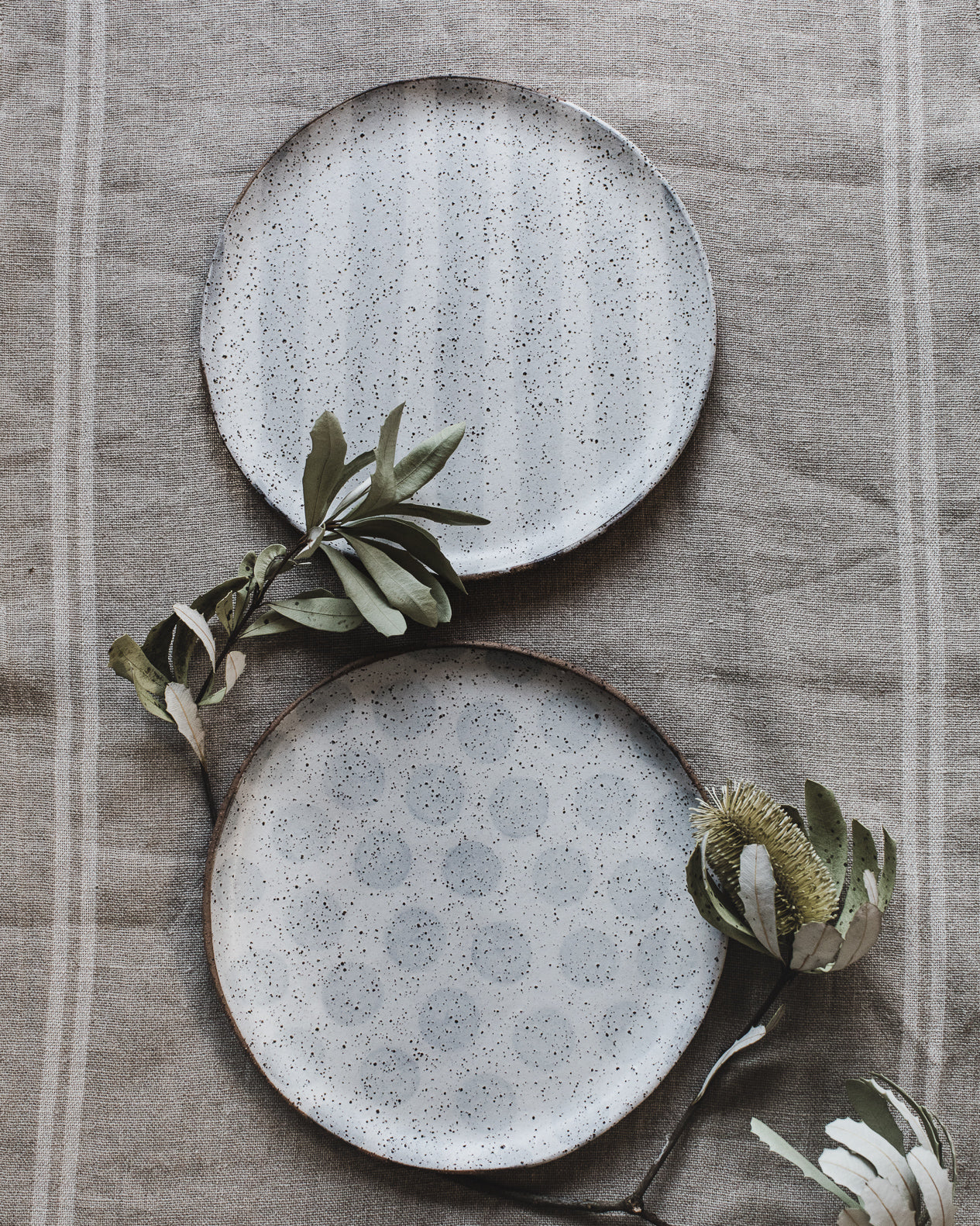 rustic speckled patterned with stripes and polka dots plates suitable to hold 10 inch cake handmade by clay beehive ceramics