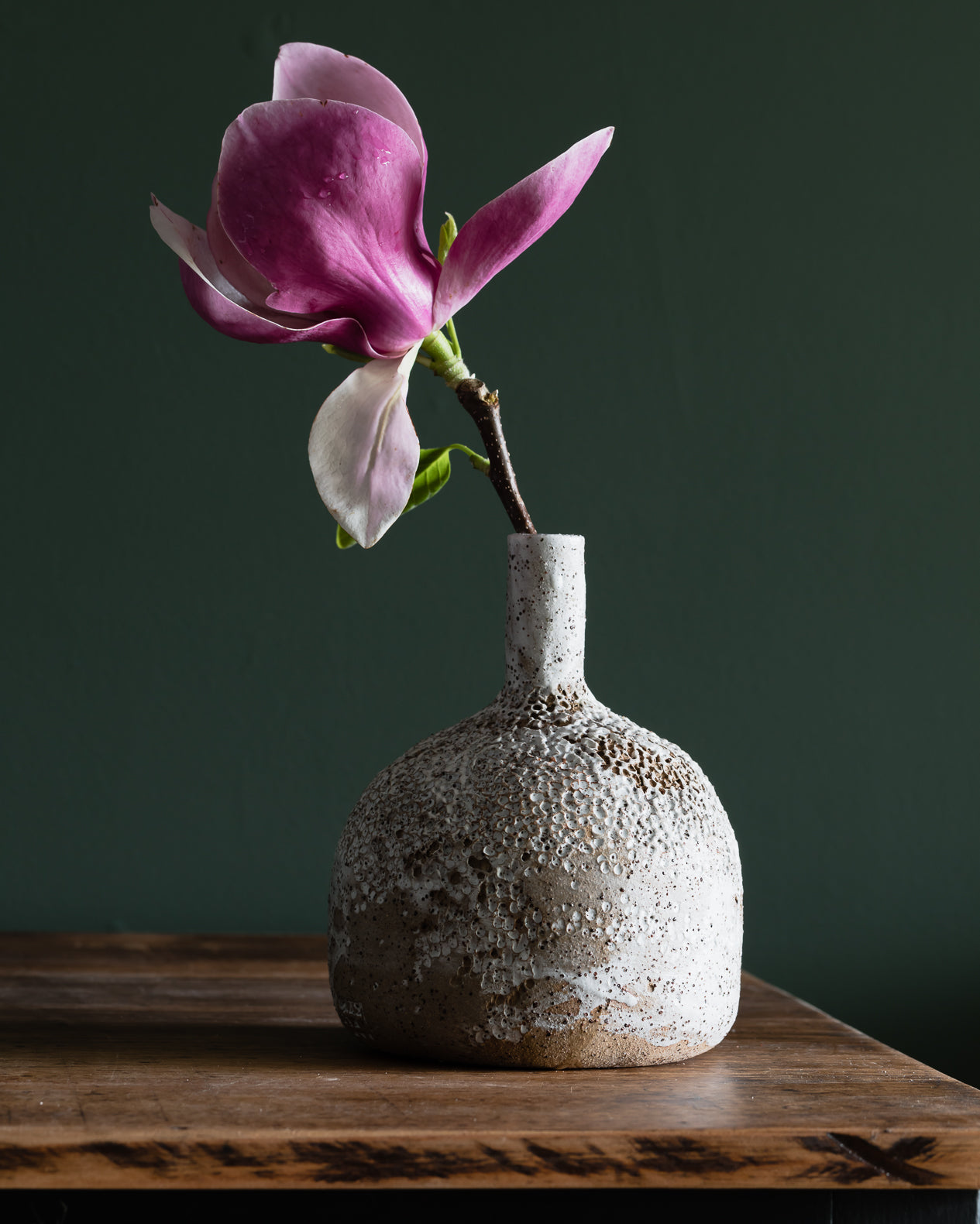 Large bottle shaped textured vase with long neck, glazed in a matte white finish, contrasting against the rustic speckled tan clay body, handmade by Clay Beehive ceramics. 