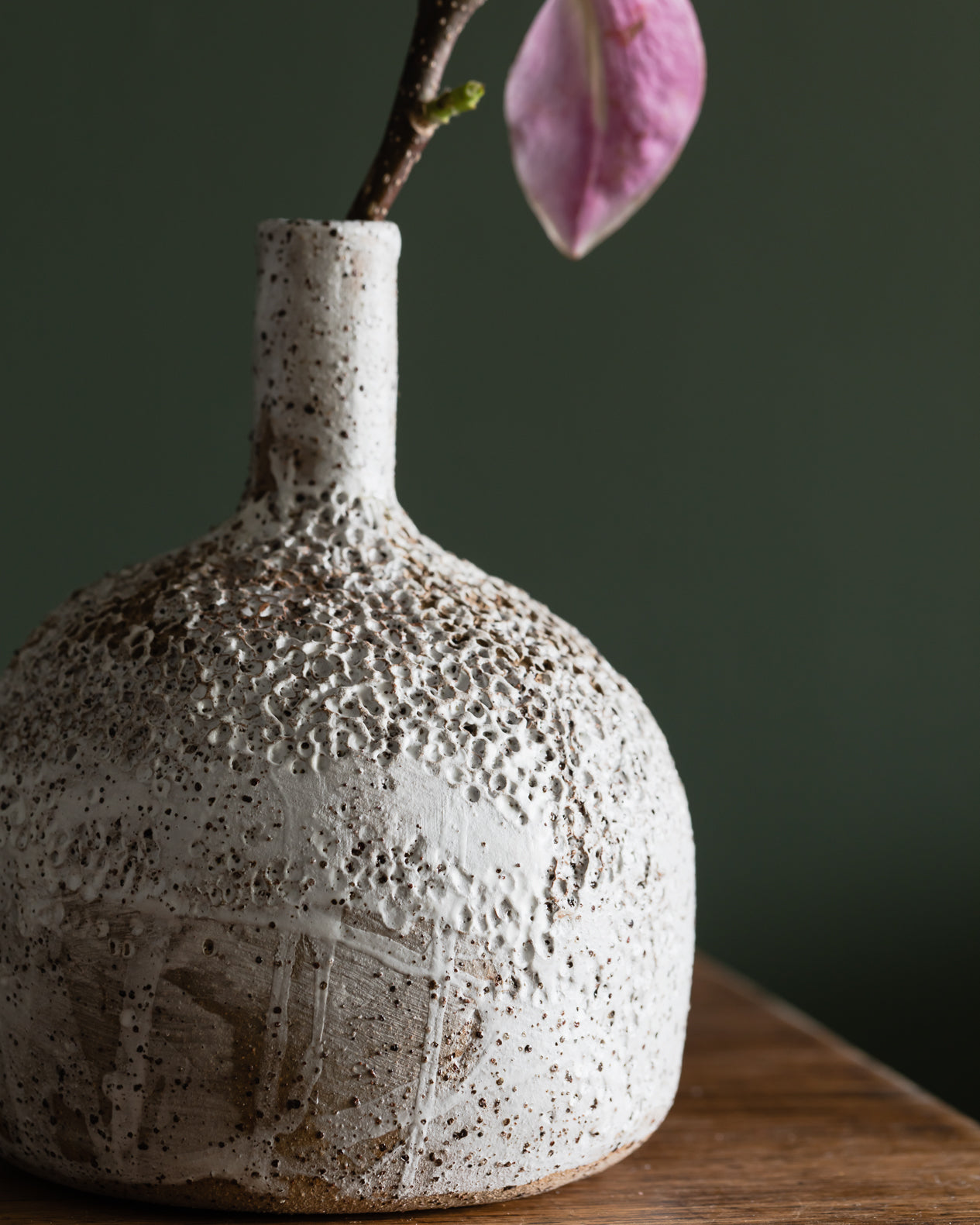 Large bottle shaped textured vase with long neck, glazed in a matte white finish, contrasting against the rustic speckled tan clay body, handmade by Clay Beehive ceramics. 