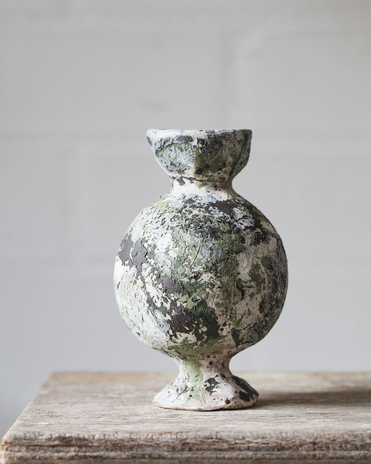 Sculptural vases with old paint patina giving them an old world feel, charming little vases with pedestal feet handmade by clay beehive ceramics