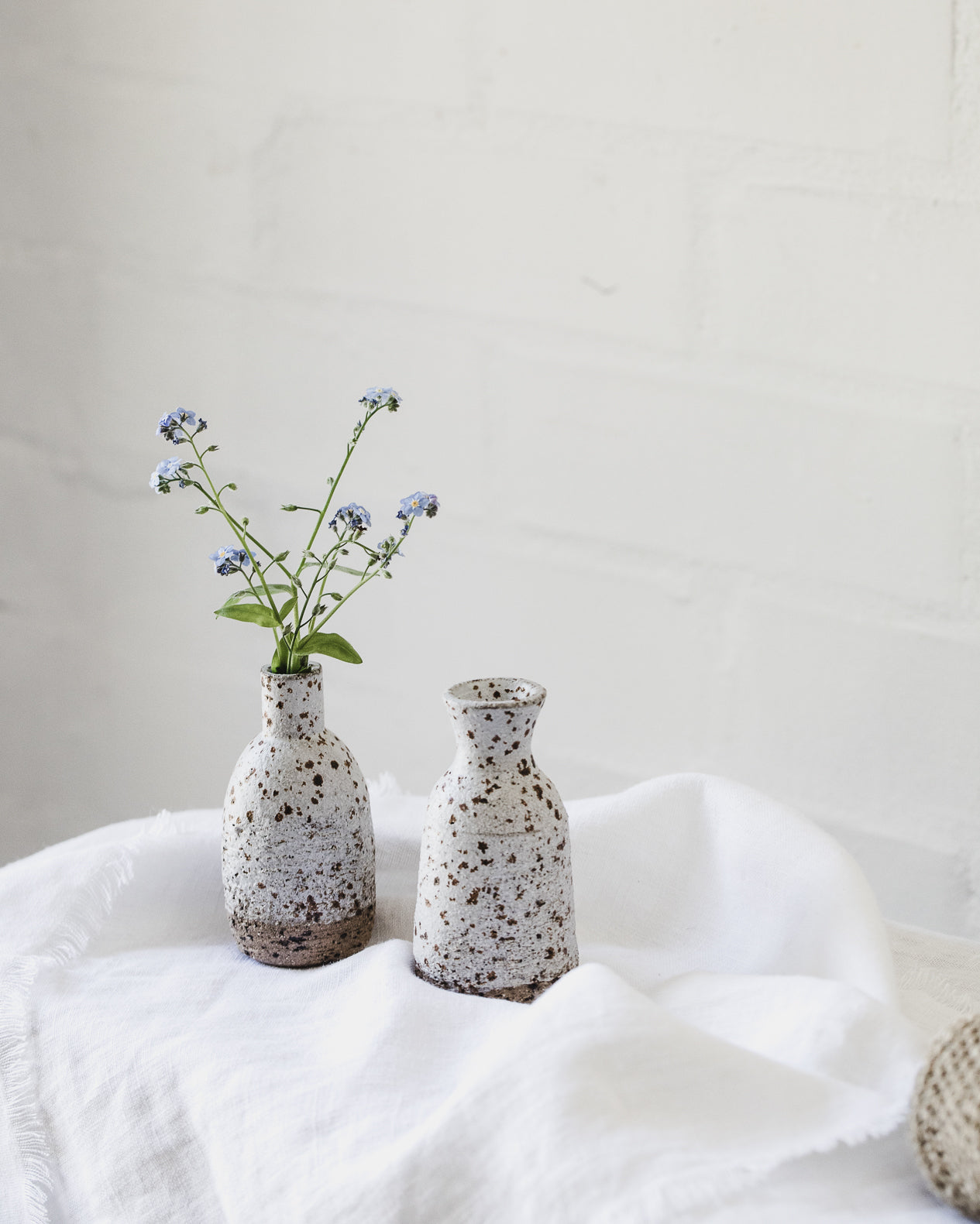 White wheel thrown speckled vases created by clay beehive ceramics 