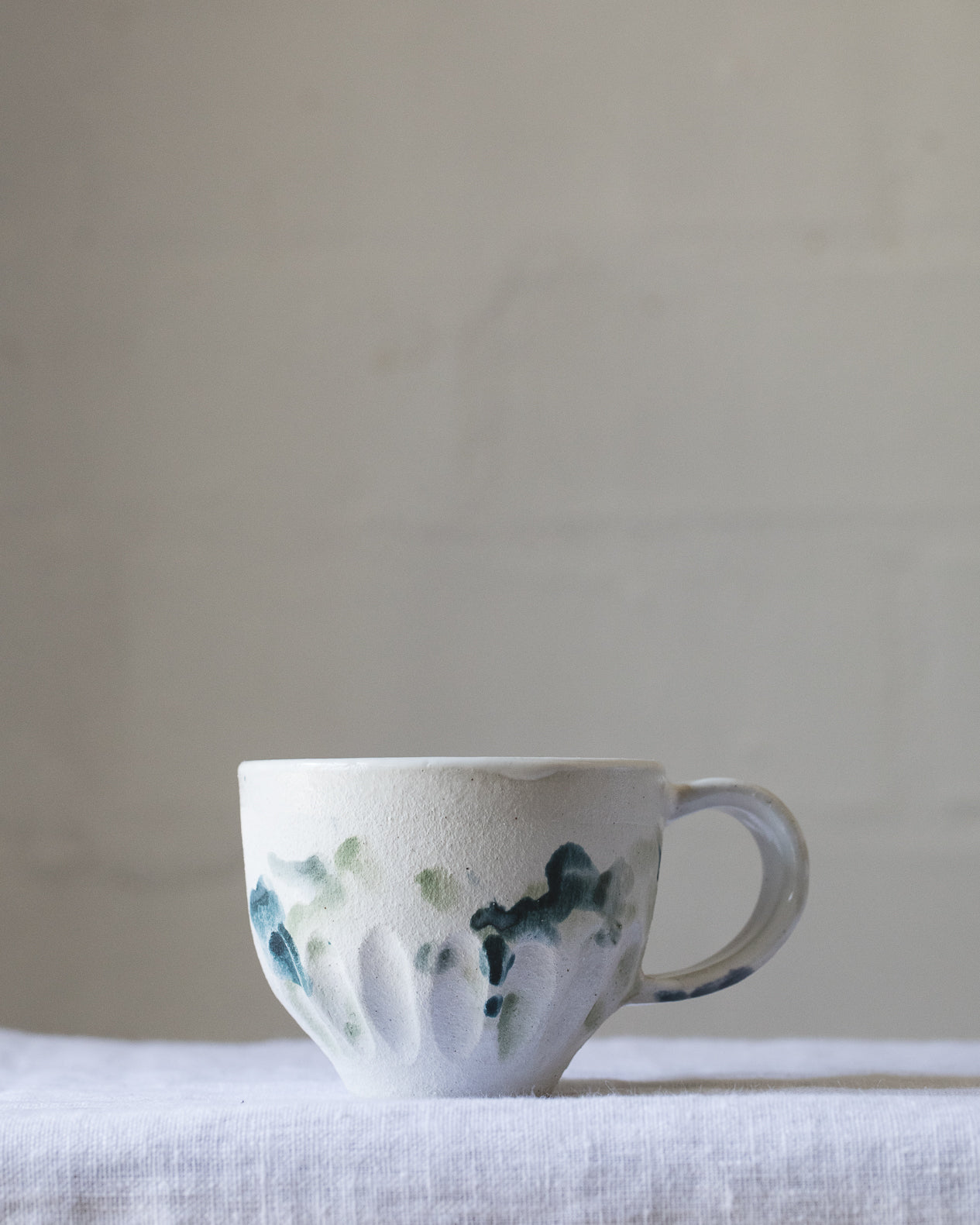 Handmade ceramic cup with handle with watercolour effect glaze created by clay beehive ceramics