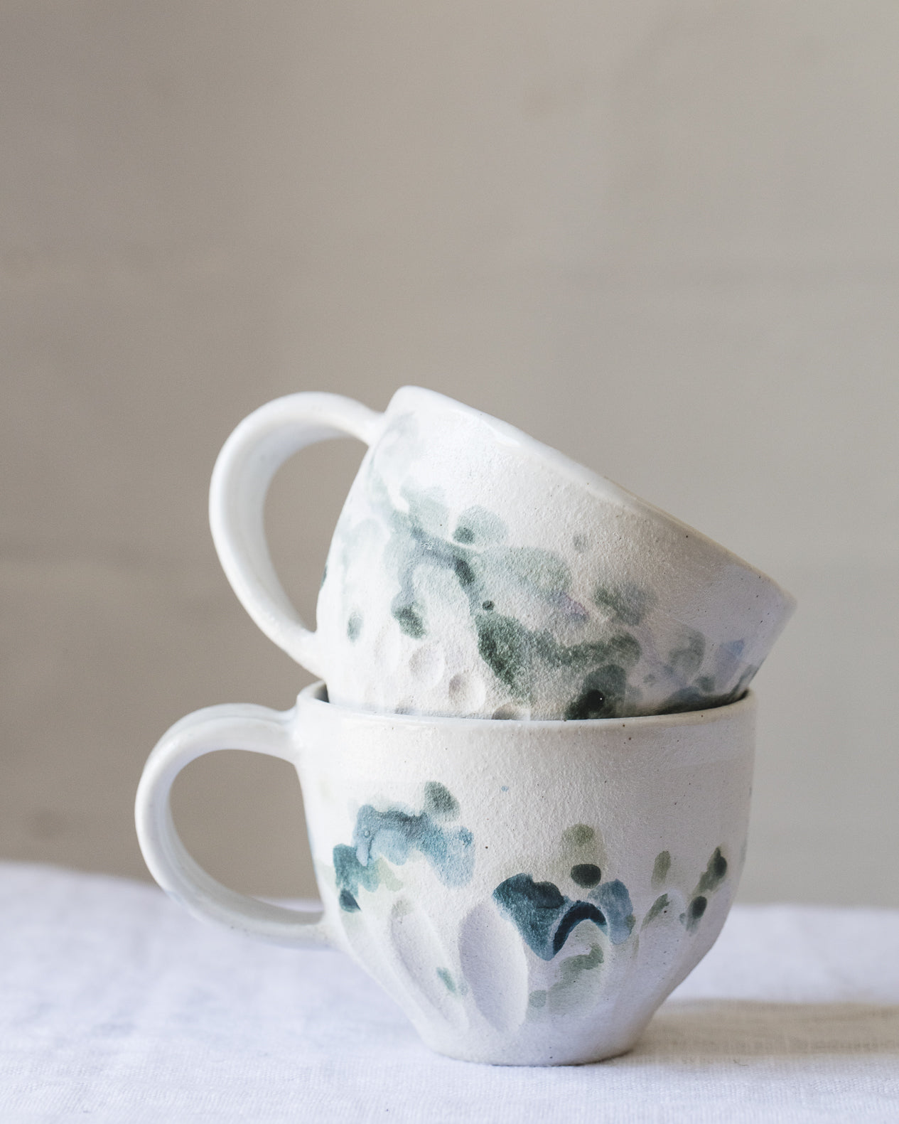 Handmade ceramic cup with handle with watercolour effect glaze created by clay beehive ceramics