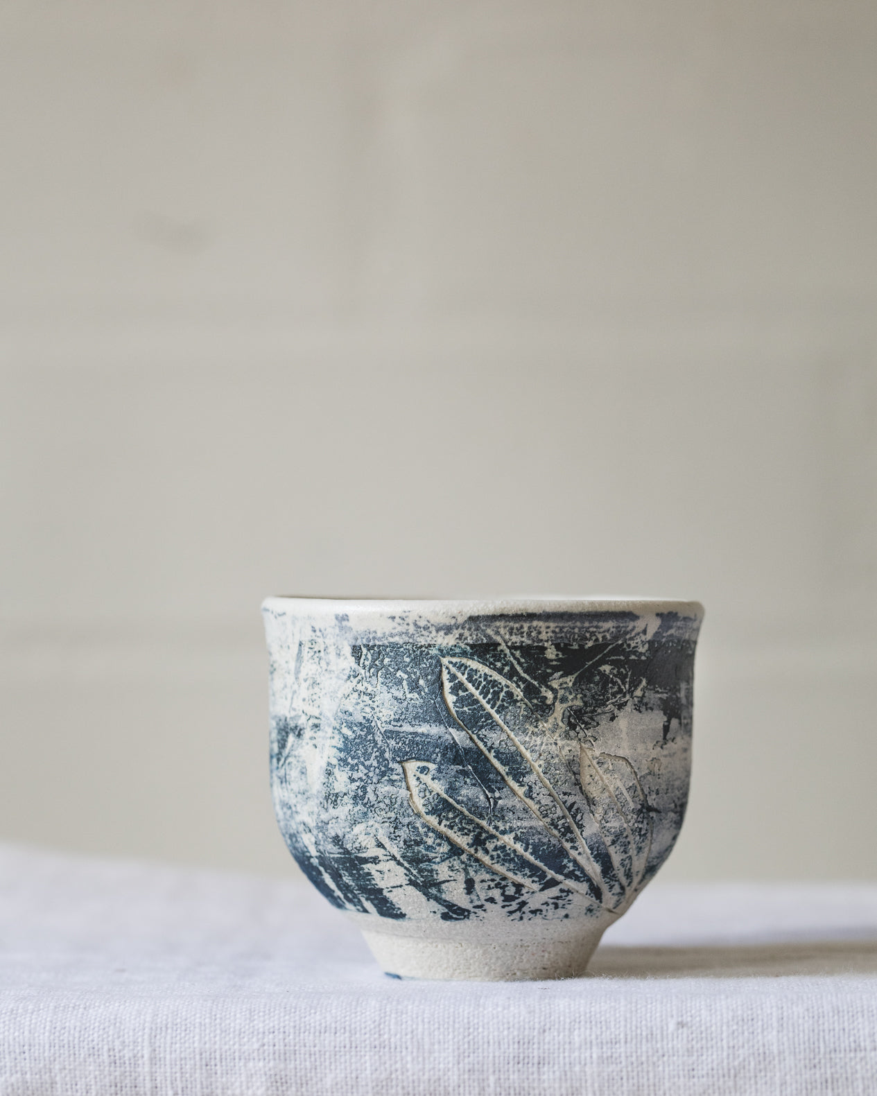 White footed cups with coloured patina surface textures hand made by clay beehive ceramics 