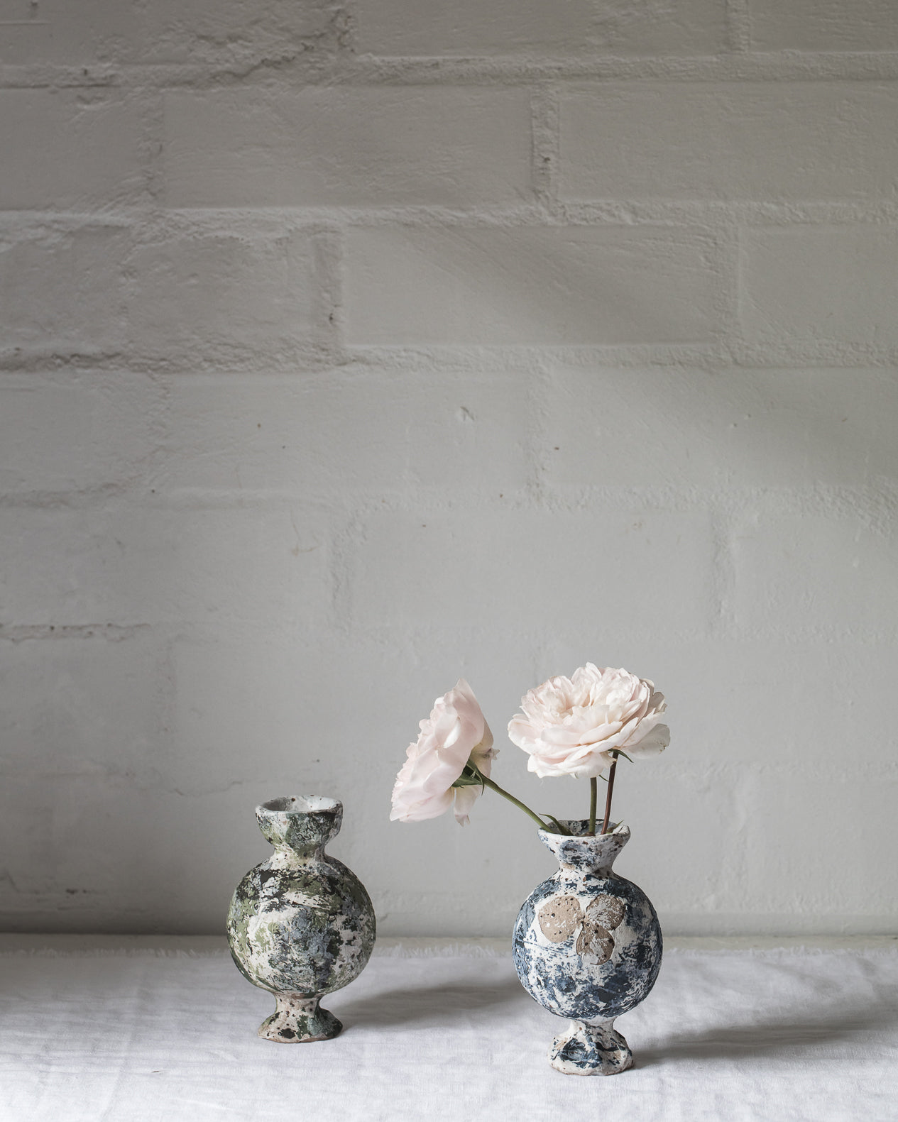 Sculptural vases with old paint patina giving them an old world feel, charming little vases with pedestal feet handmade by clay beehive ceramics