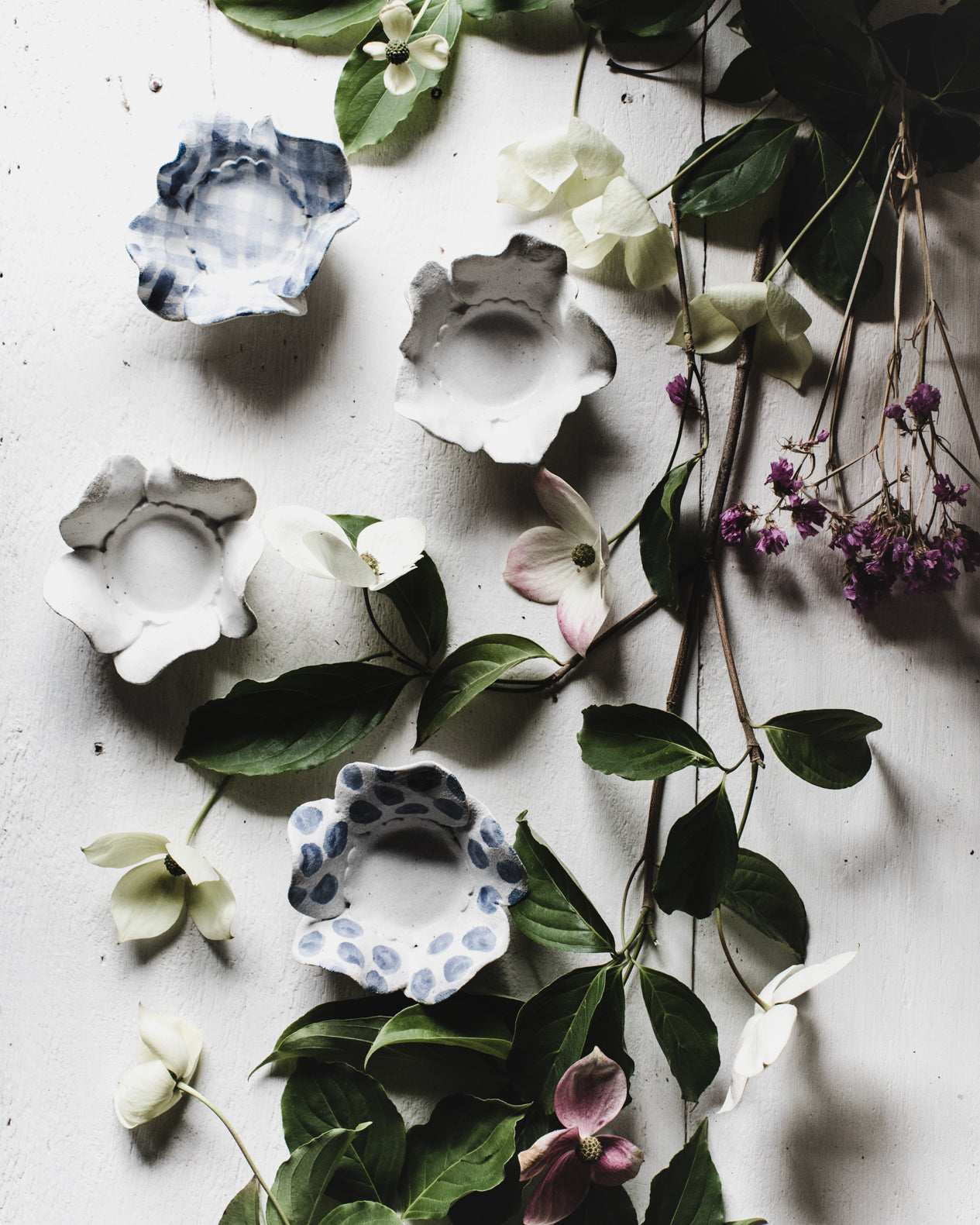 Flower shaped candle holders with spots and gingham patterns handmade by clay beehive ceramics