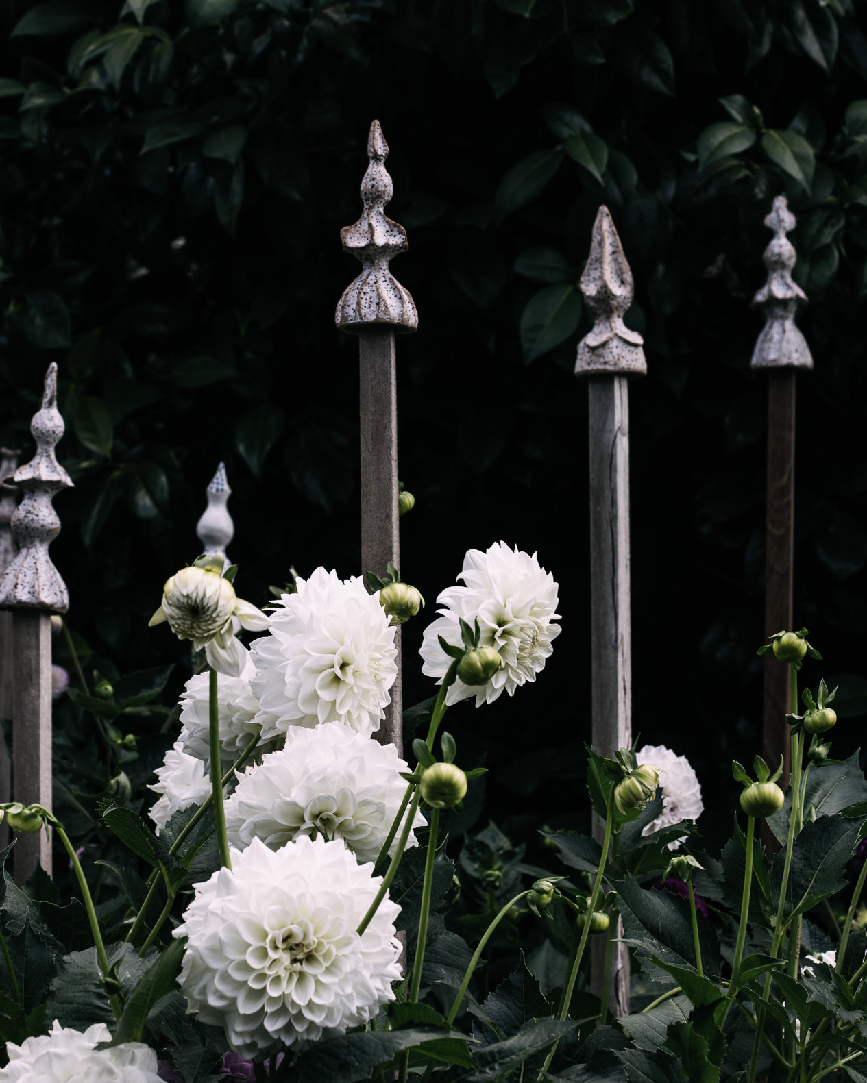 Ceramic finials in the dahlia flower garden handmade by clay beehive ceramics