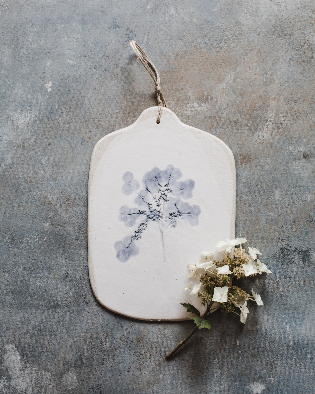 Hydrangea flower impression painted blue with a satin white finish cheeseboard by clay beehive ceramics