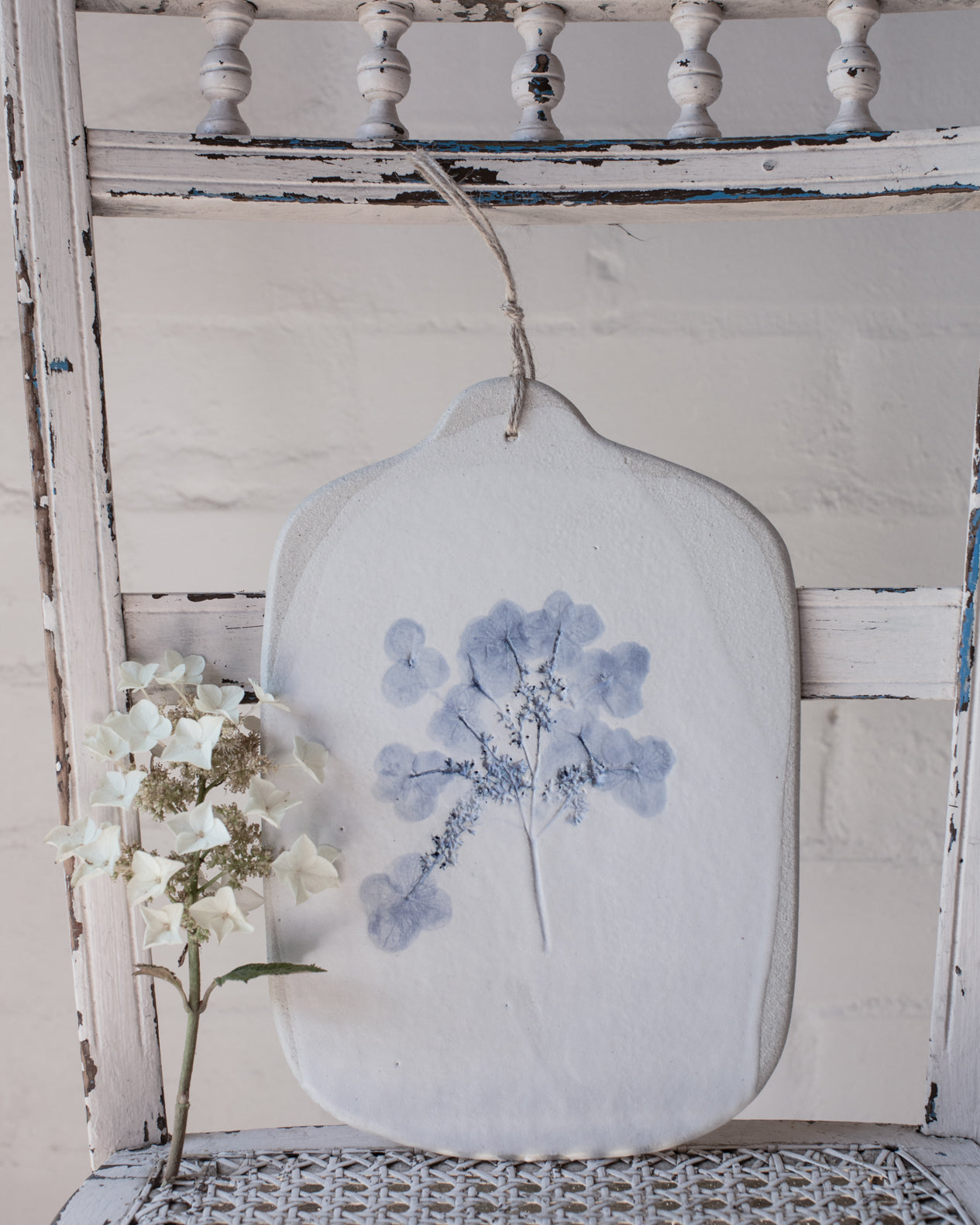 Hydrangea flower impression painted blue with a satin white finish cheeseboard by clay beehive ceramics