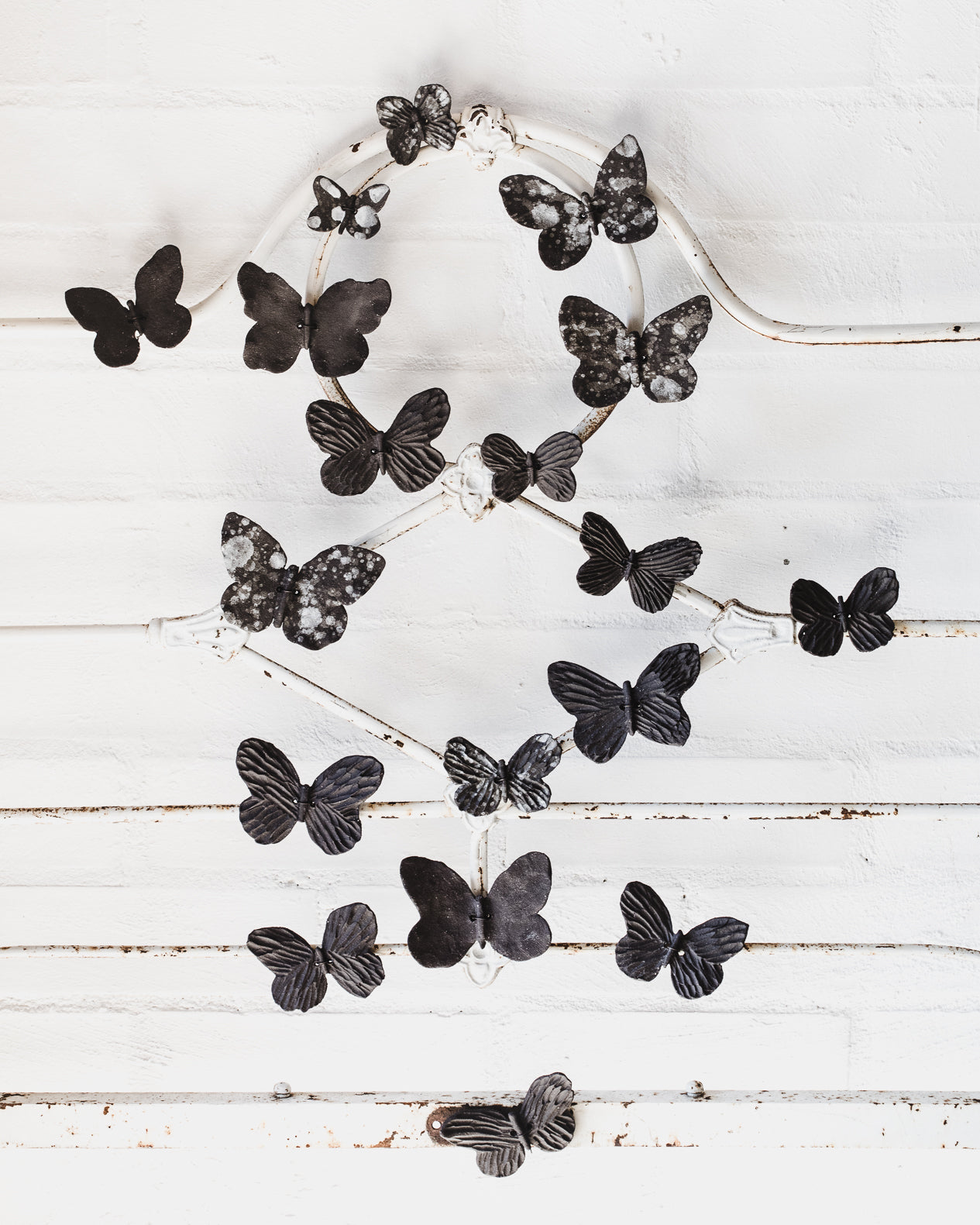 Black ceramic butterflies with white speckles and texture, wires attached for easy mounting and hanging, created by clay beehive ceramics