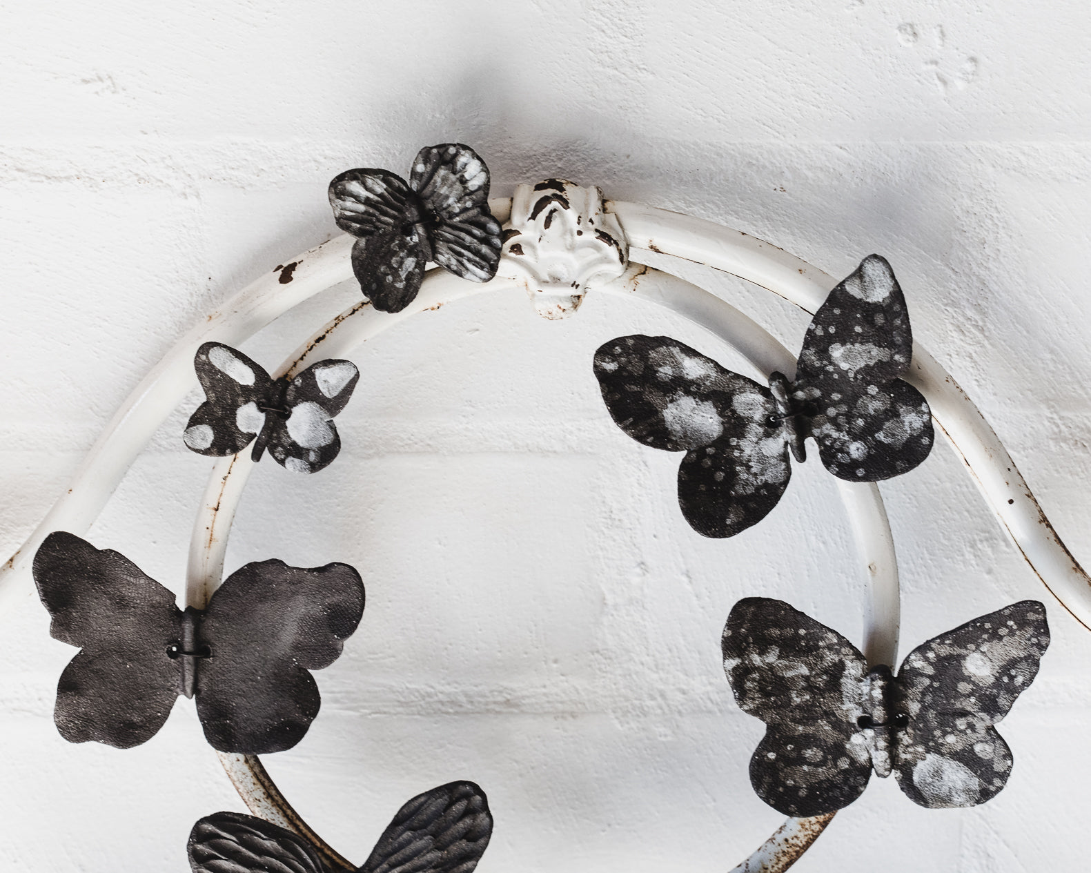Black ceramic butterflies with white speckles and texture, wires attached for easy mounting and hanging, created by clay beehive ceramics