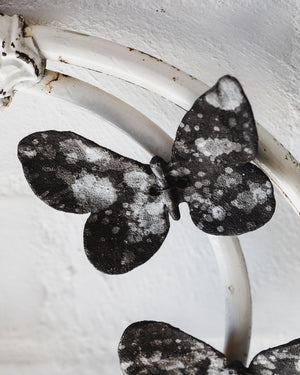 Black ceramic butterflies with white speckles and texture, wires attached for easy mounting and hanging, created by clay beehive ceramics