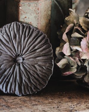 Closeup details of carved ceramic flower in black by clay beehive ceramics