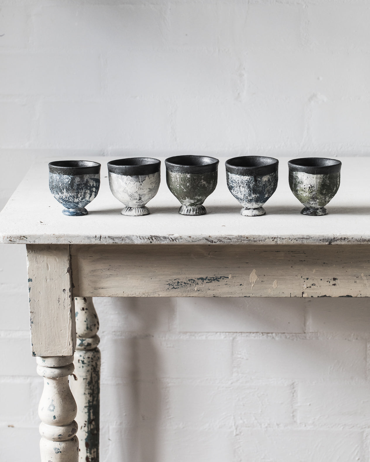 Footed goblet cups with chippy paint patina hand crafted by clay beehive ceramics