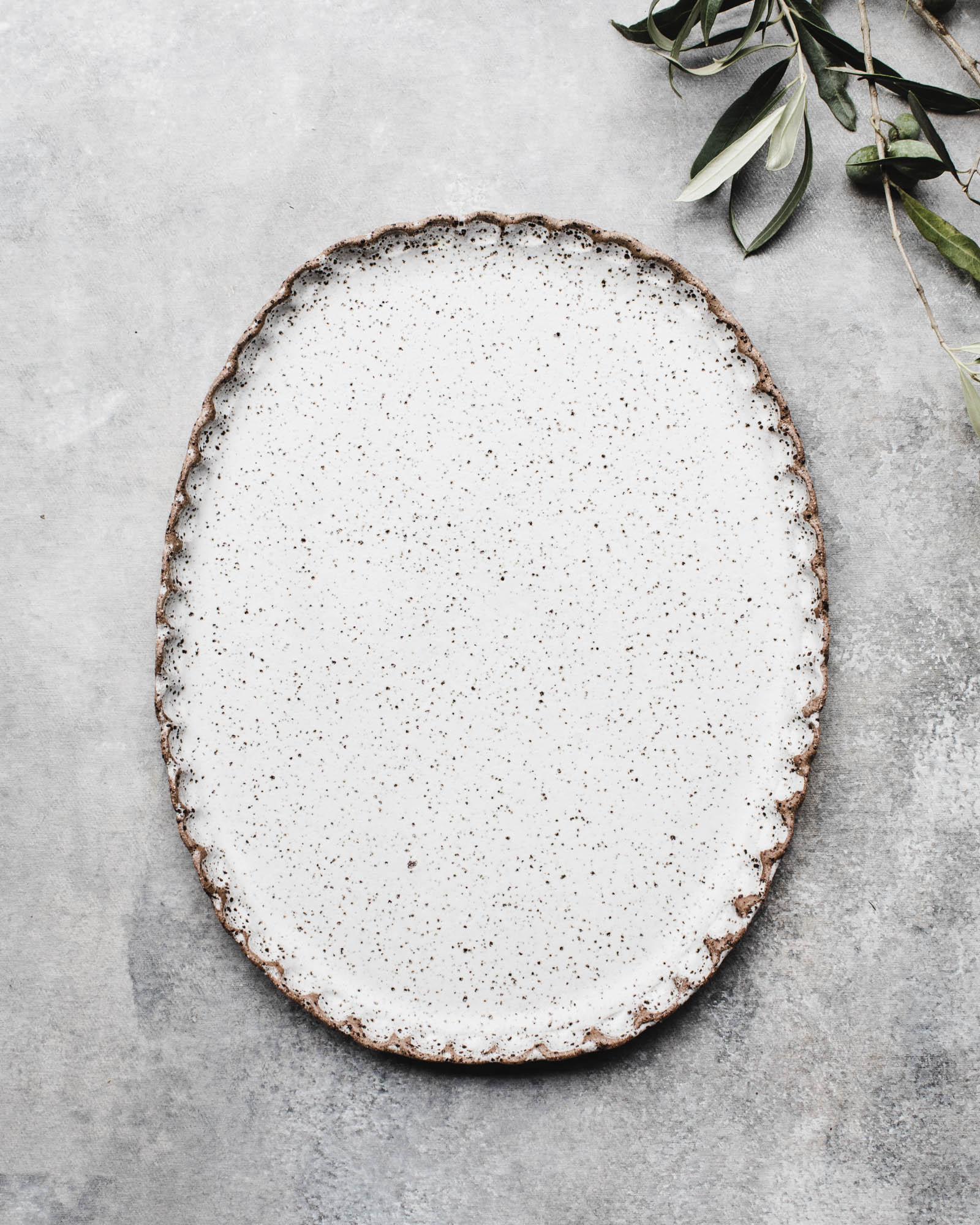 Scalloped rim oval speckled white platter by clay beehive ceramics