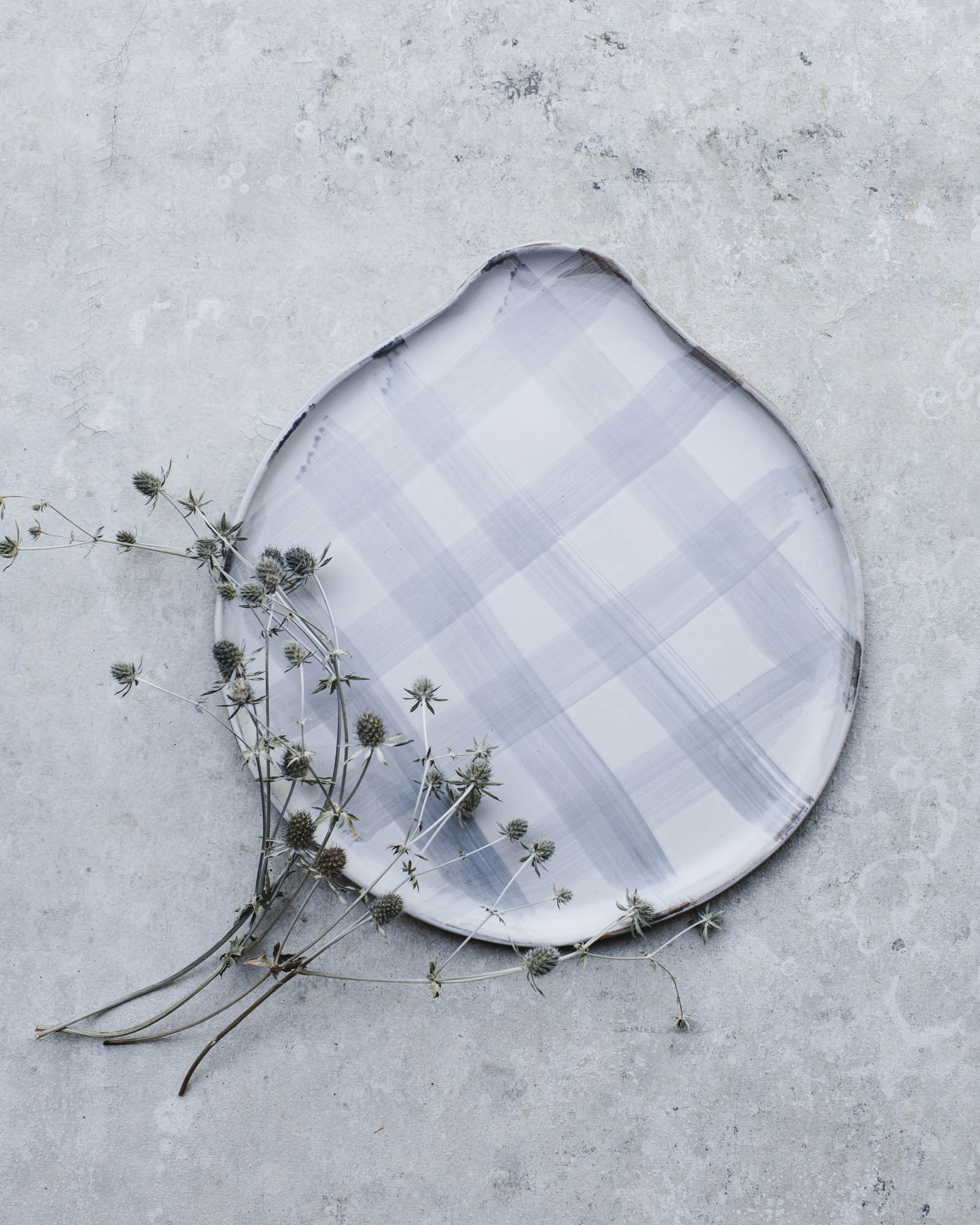 Grey tartan pattern rounded platter with handle handmade by clay beehive ceramics