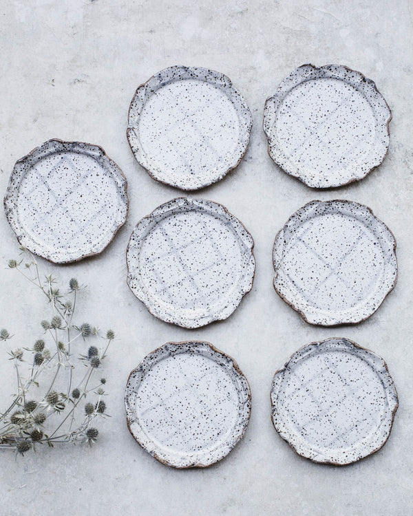 Gritty rustic cake plates with line patterns and decorative earth orga ...