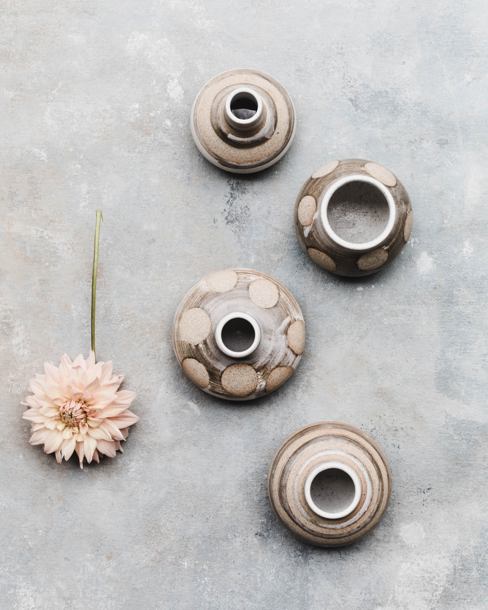 Wheel thrown bud vases with a speckled tan / patterned decoration by clay beehive ceramics