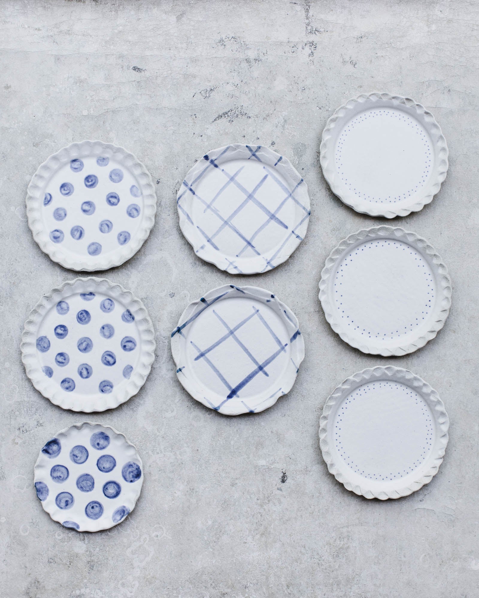 Handmade ceramic cake plates with decorative rims in blue and white patterns by clay beehive ceramics