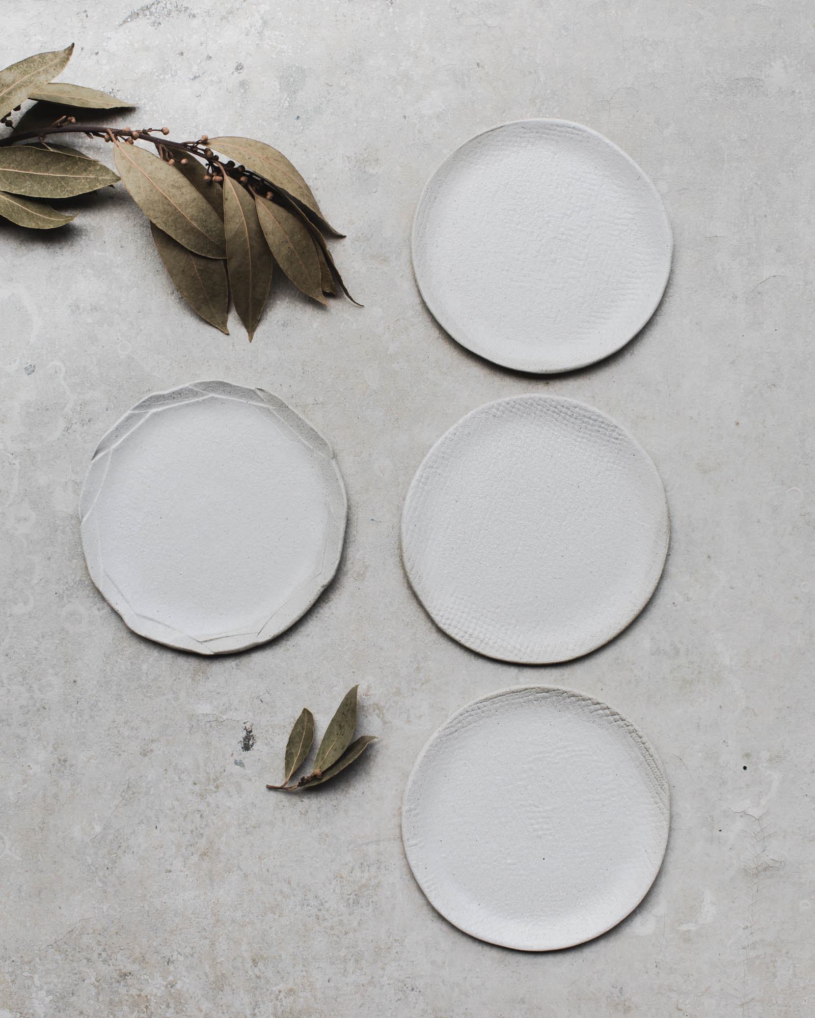 Matte white sandy textured handmade plates by clay beehive
