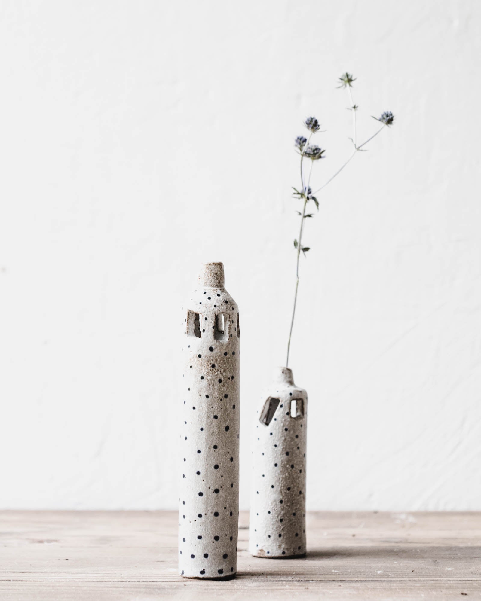 Rustic slender tiny spot bud vases with decorative cutout details handmade by clay beehive ceramics.