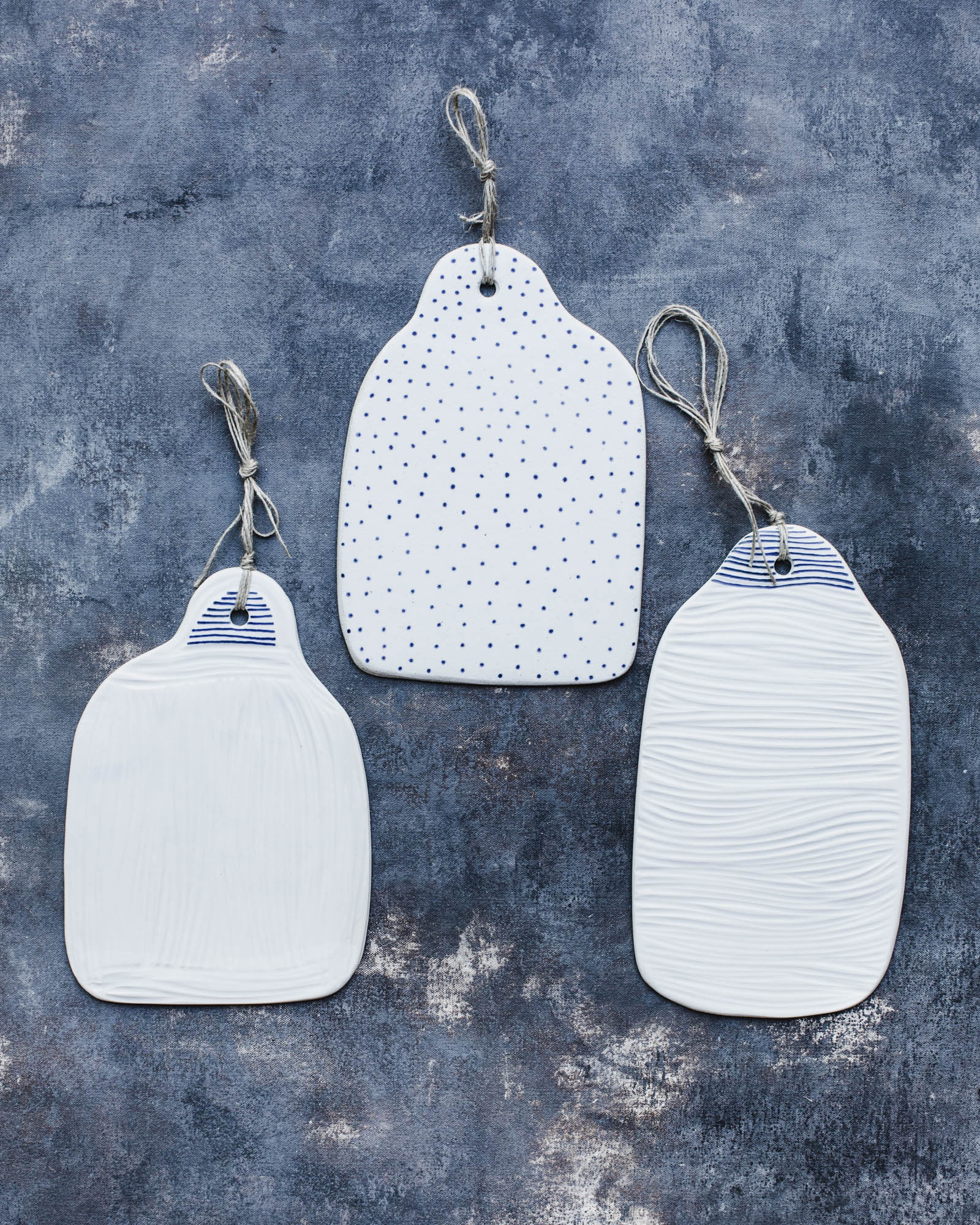 ceramic handmade cheese platter with carvings and blue and white coastal decorations by clay beehive