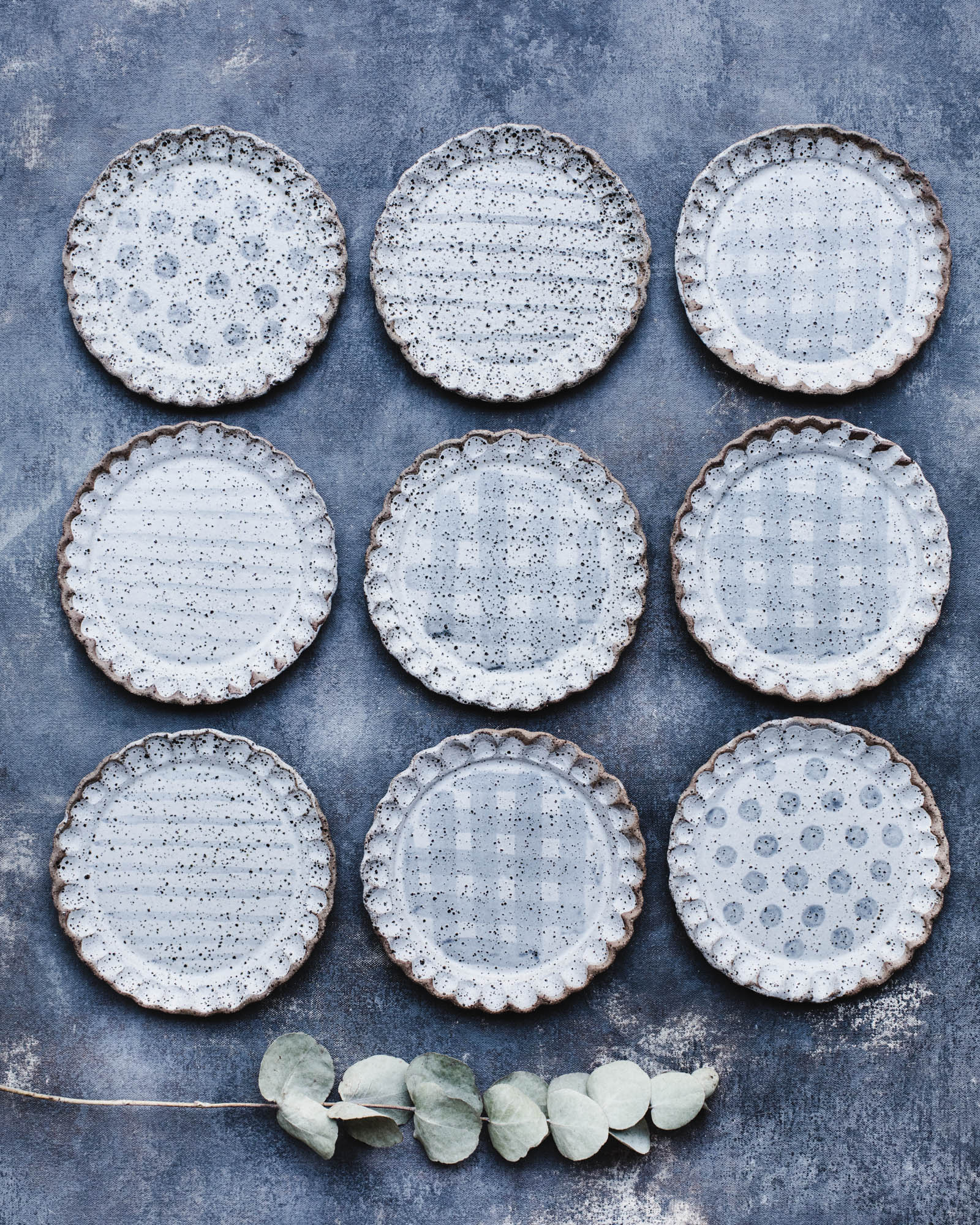 Gritty speckled scalloped rim cake plates with decorative patterns