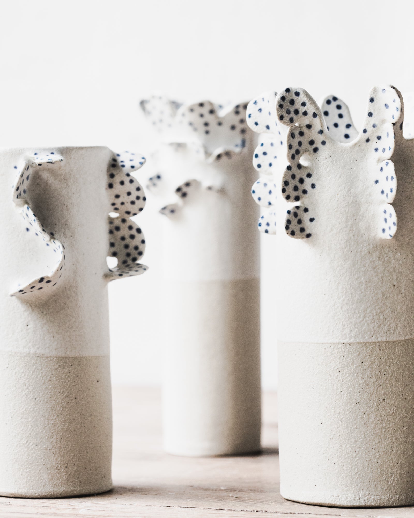 Handmade vases with scallop details and blue freckles by clay beehive ceramics