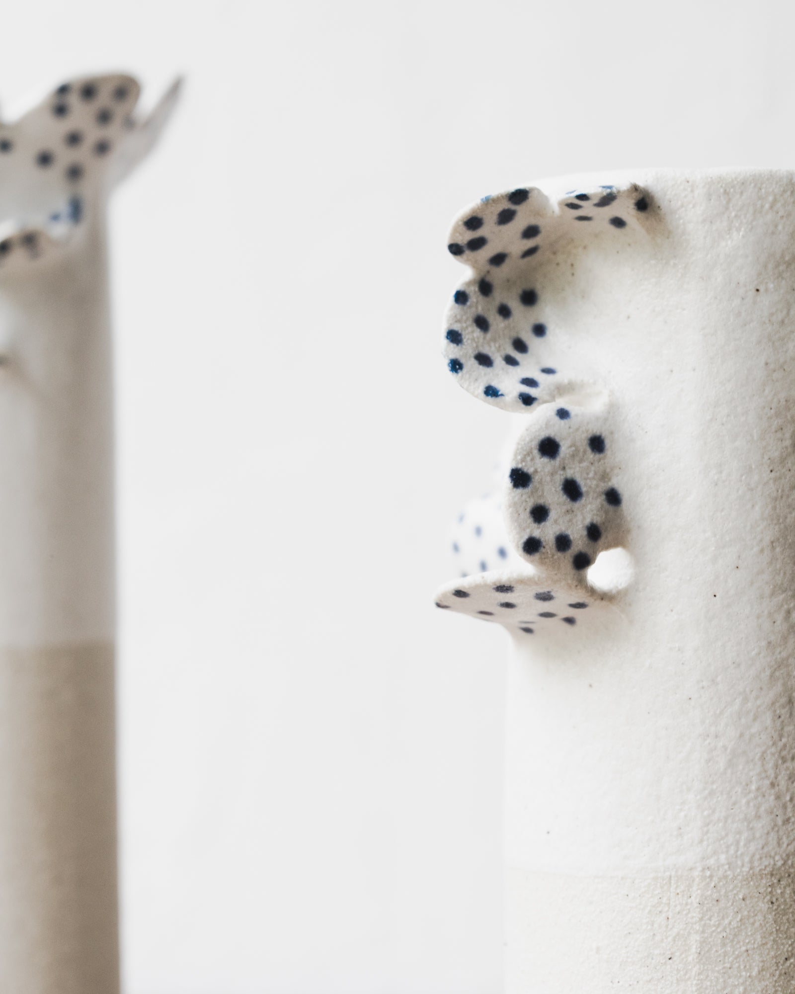 Handmade vases with scallop details and blue freckles by clay beehive ceramics