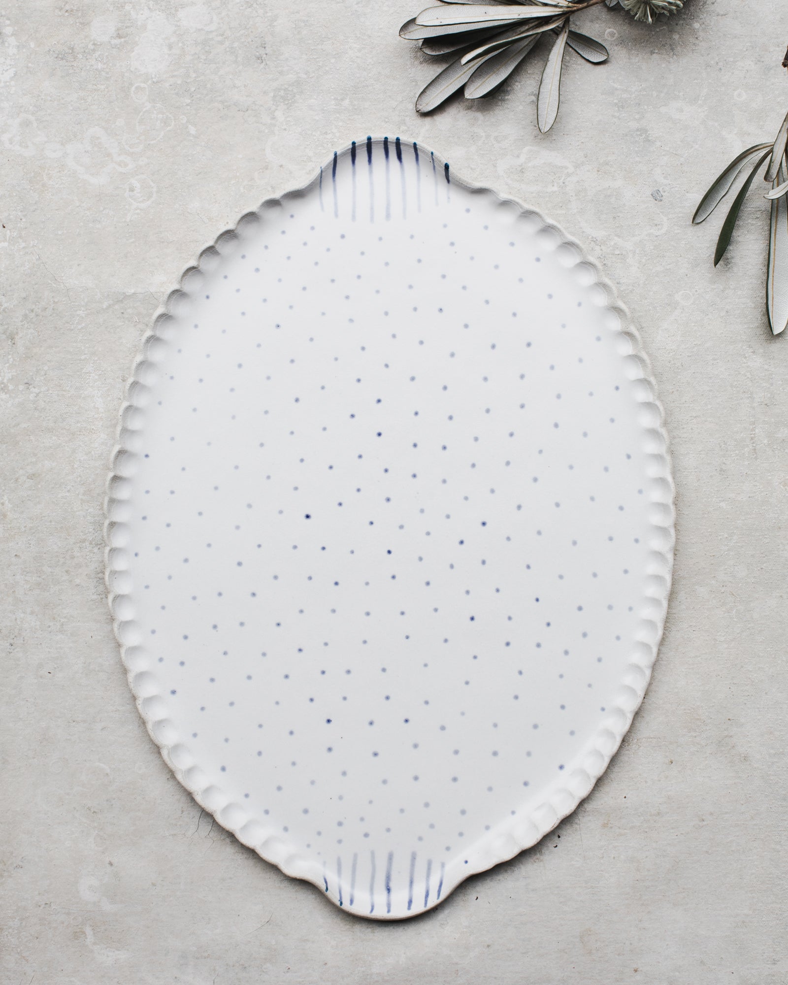 Handmade platter with easy grip handles decorated in blue and white spots and lines by clay beehive ceramics