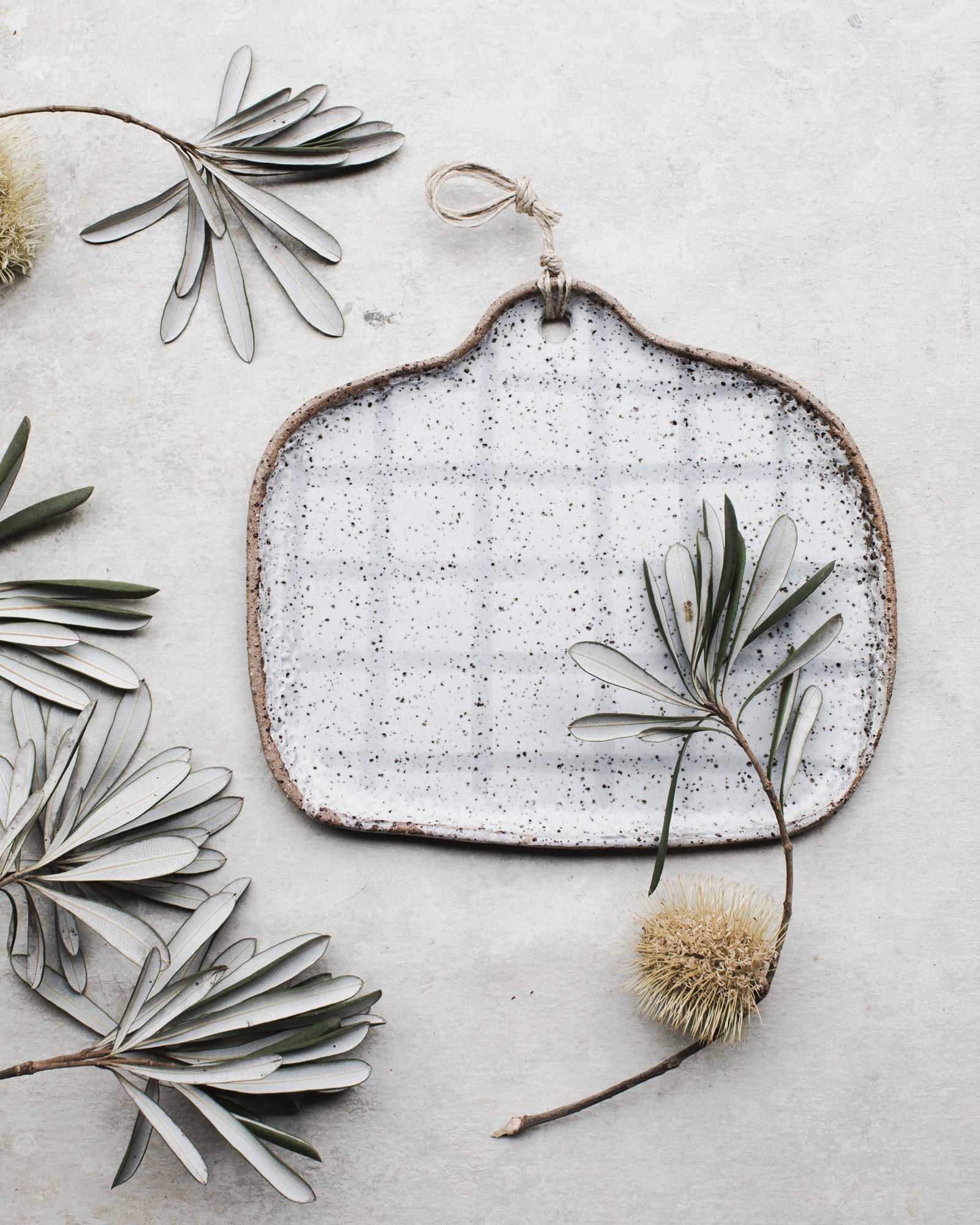 Handmade ceramic rectangular platter with cutout handle with decorative grey grid line pattern by clay beehive ceramics