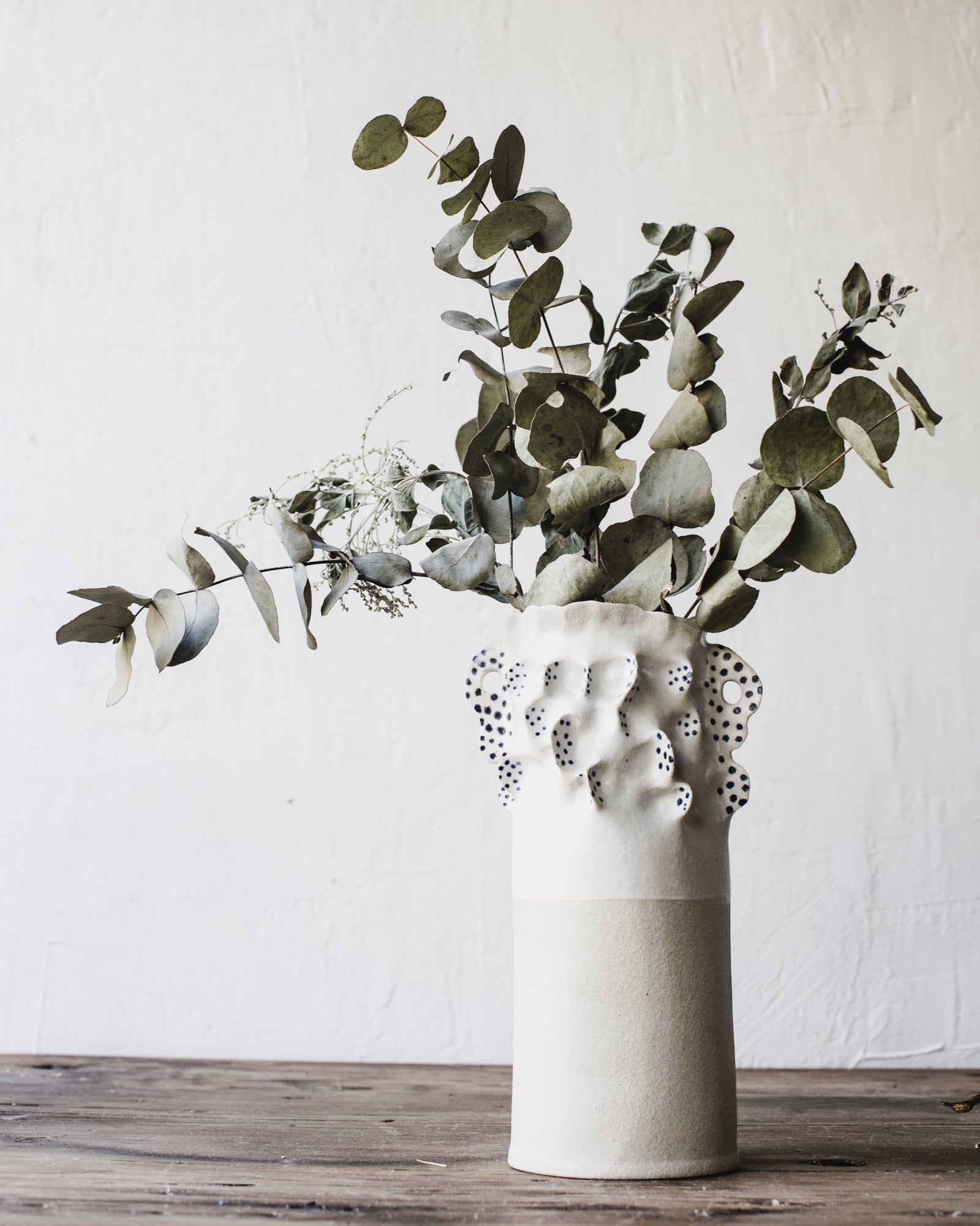 Pinched white large vase decorated with blue spots and ears handmade by clay beehive ceramics