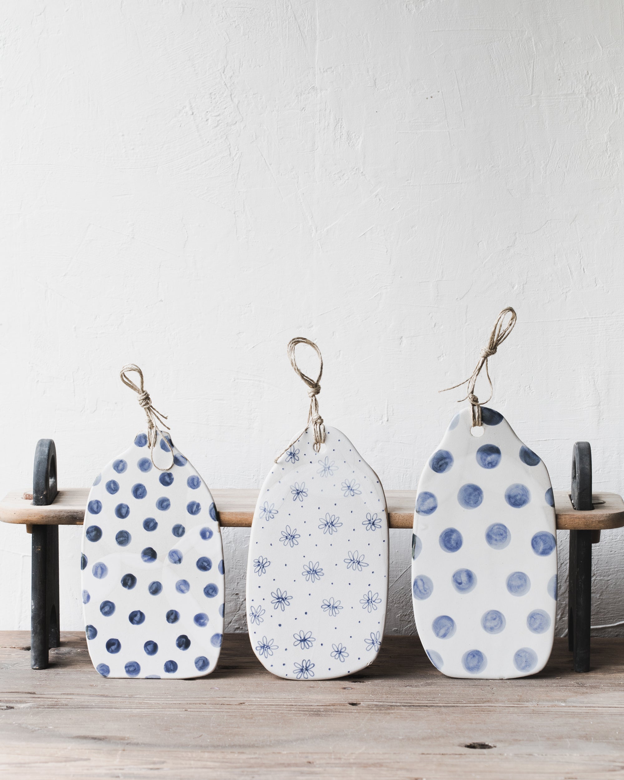 Rustic Blue and white patterned cheeseboards with hemp cord handmade by Clay Beehive ceramics