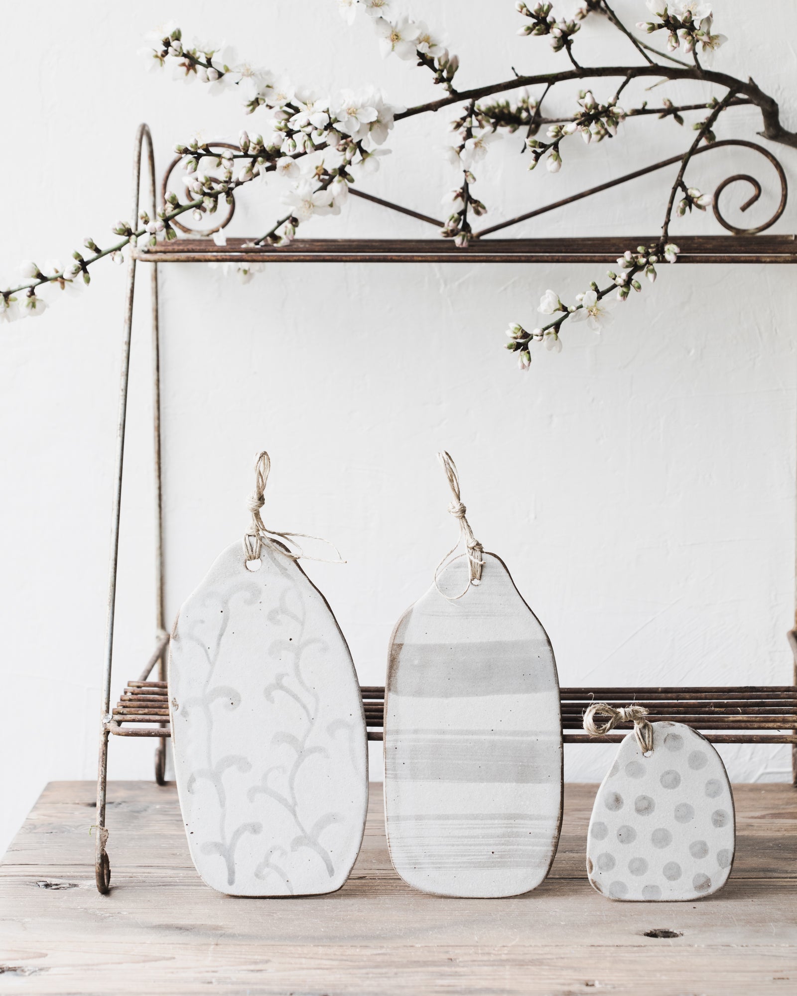 Handmade cheeseboards with patterns and hemp cord designed by Clay Beehive Ceramics