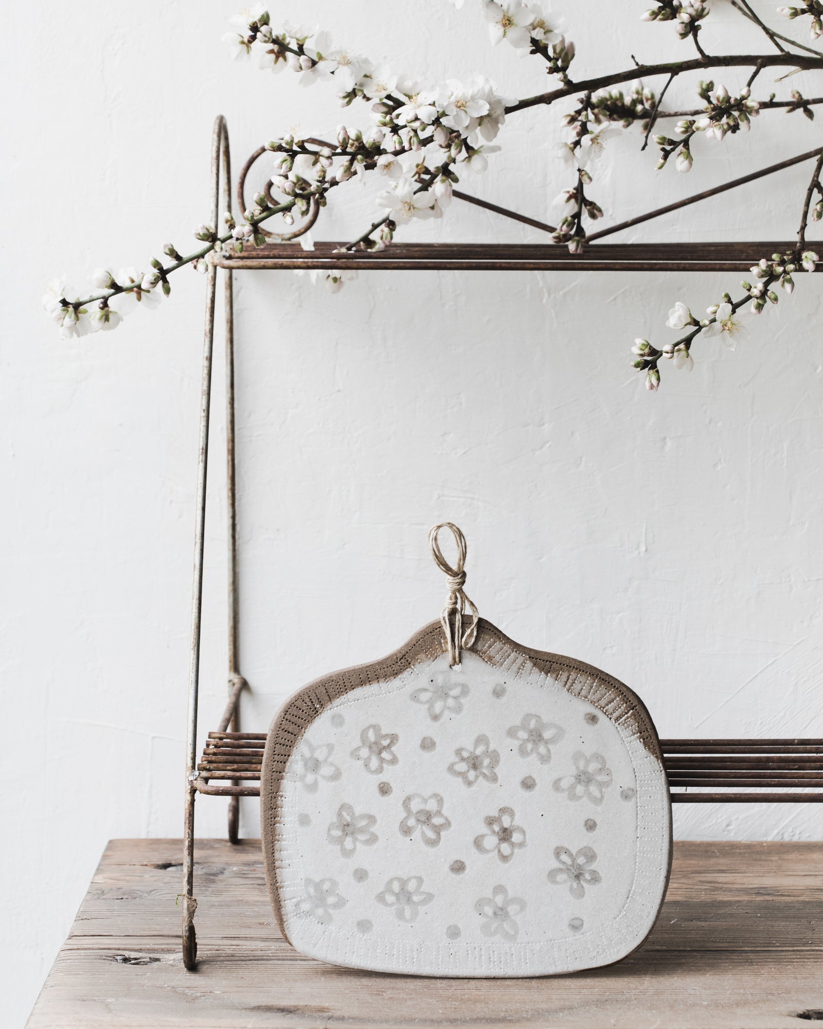 Handmade cheese board platter with hemp cord and flower patterned white/grey by clay beehive ceramics