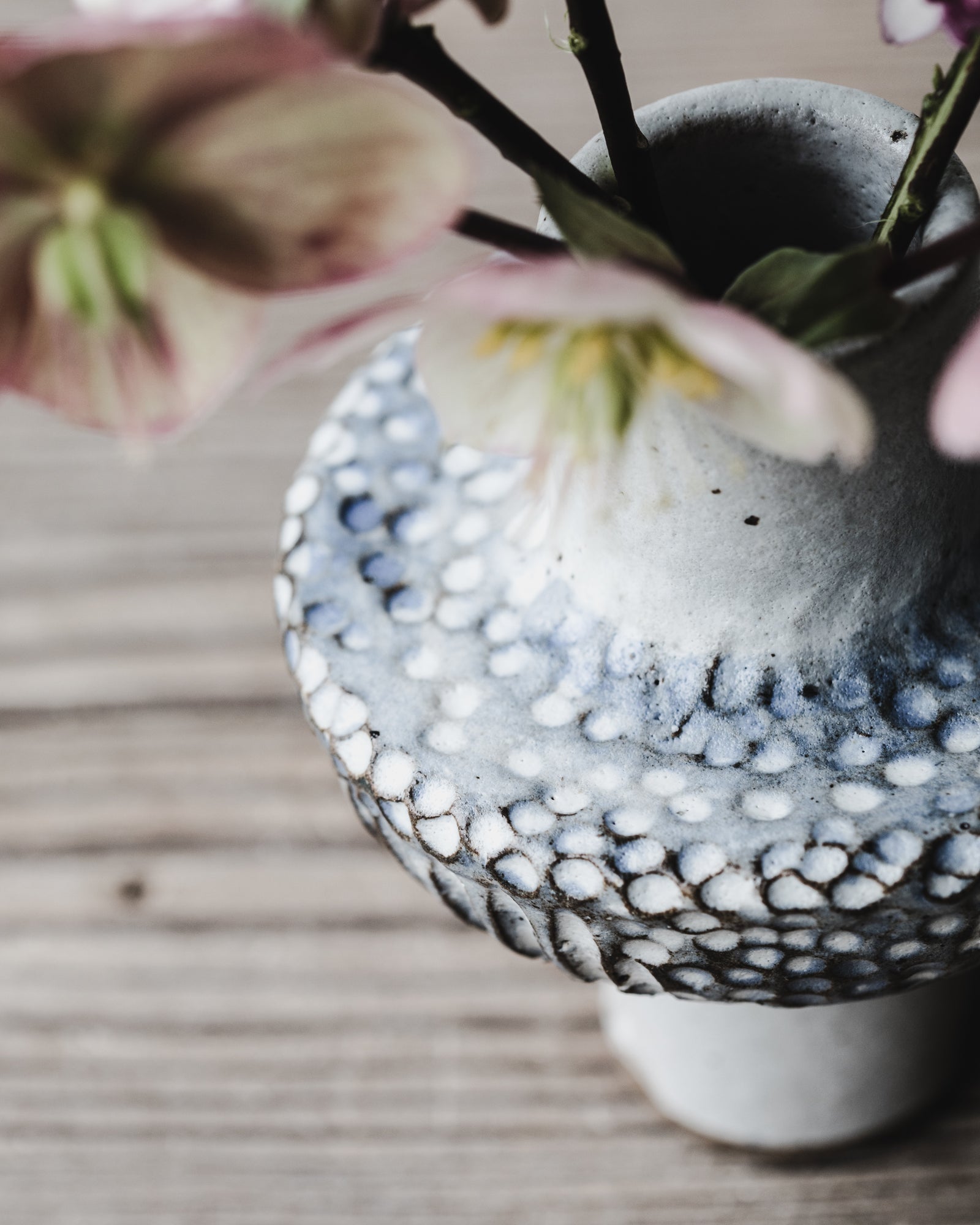 Pod bud vase with tall foot and spotty carved textured body in blue/white glaze handmade by clay beehive ceramics