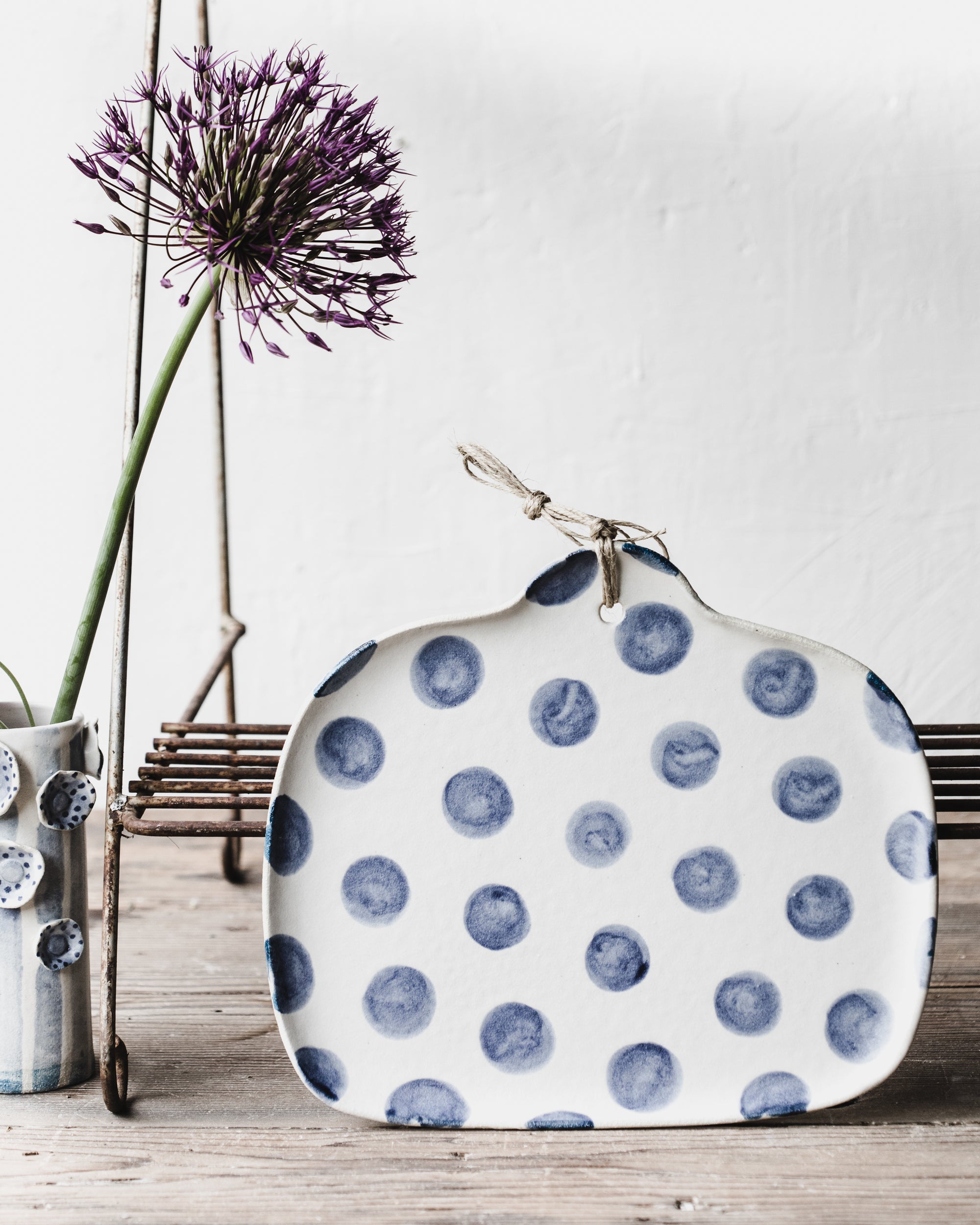 Navy Blue polka dot square cheeseboard with easy grip handle and hemp cord handmade by clay beehive ceramics