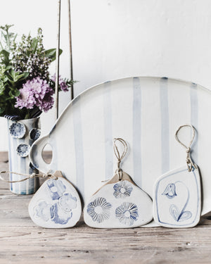 Blue and white ceramic Cheeseboards with decorative patterns and illustrations by clay beehive ceramics