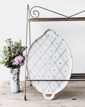 Blue and white patterned platters with cutout handles handcrafted by clay beehive ceramics
