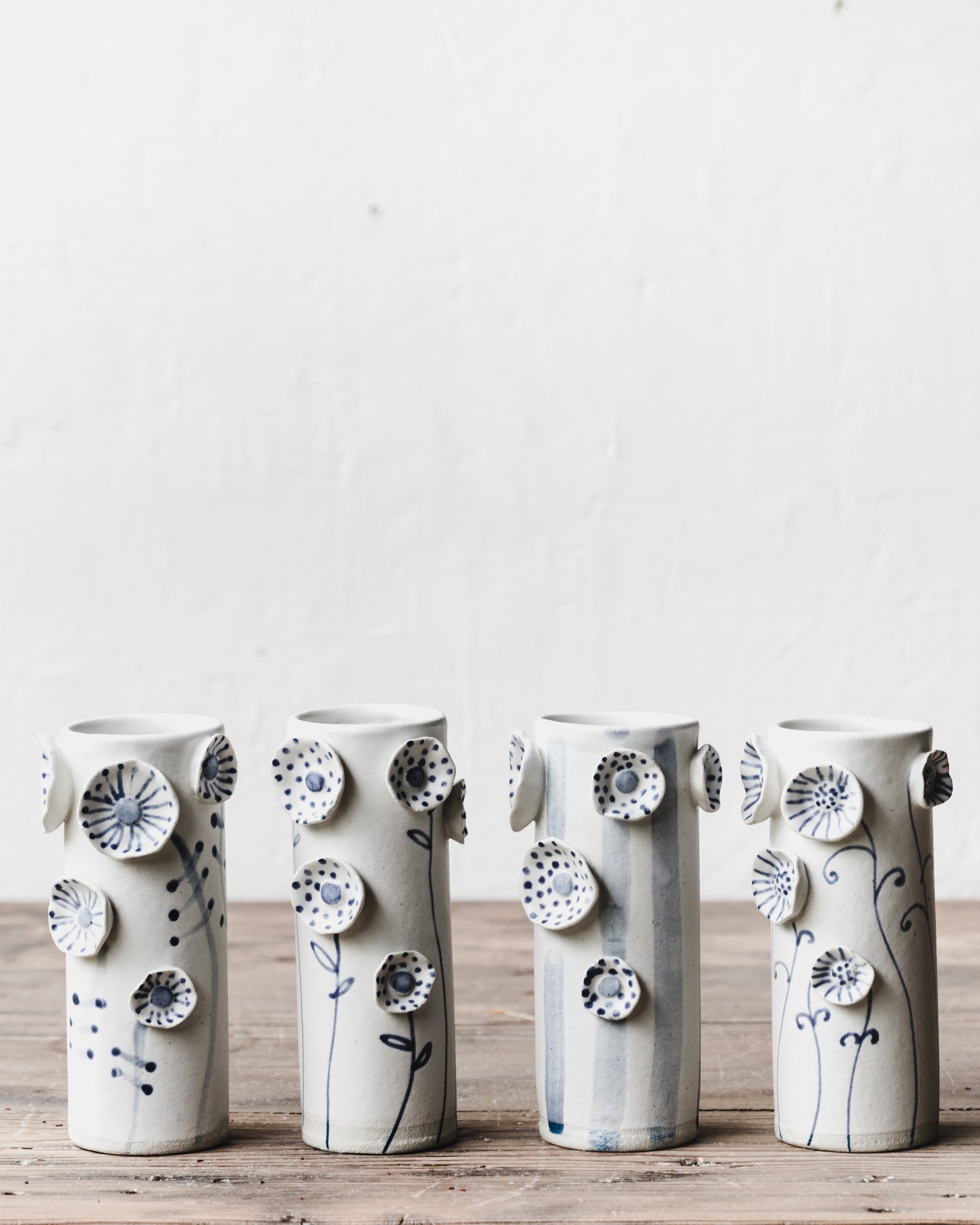 Flower vases with blue and white stem and line decorations by clay beehive ceramics